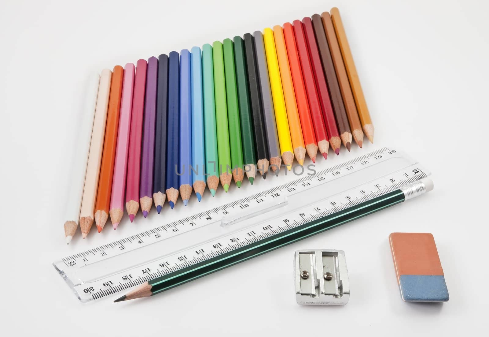 Very tidy basic school supplies on a white background