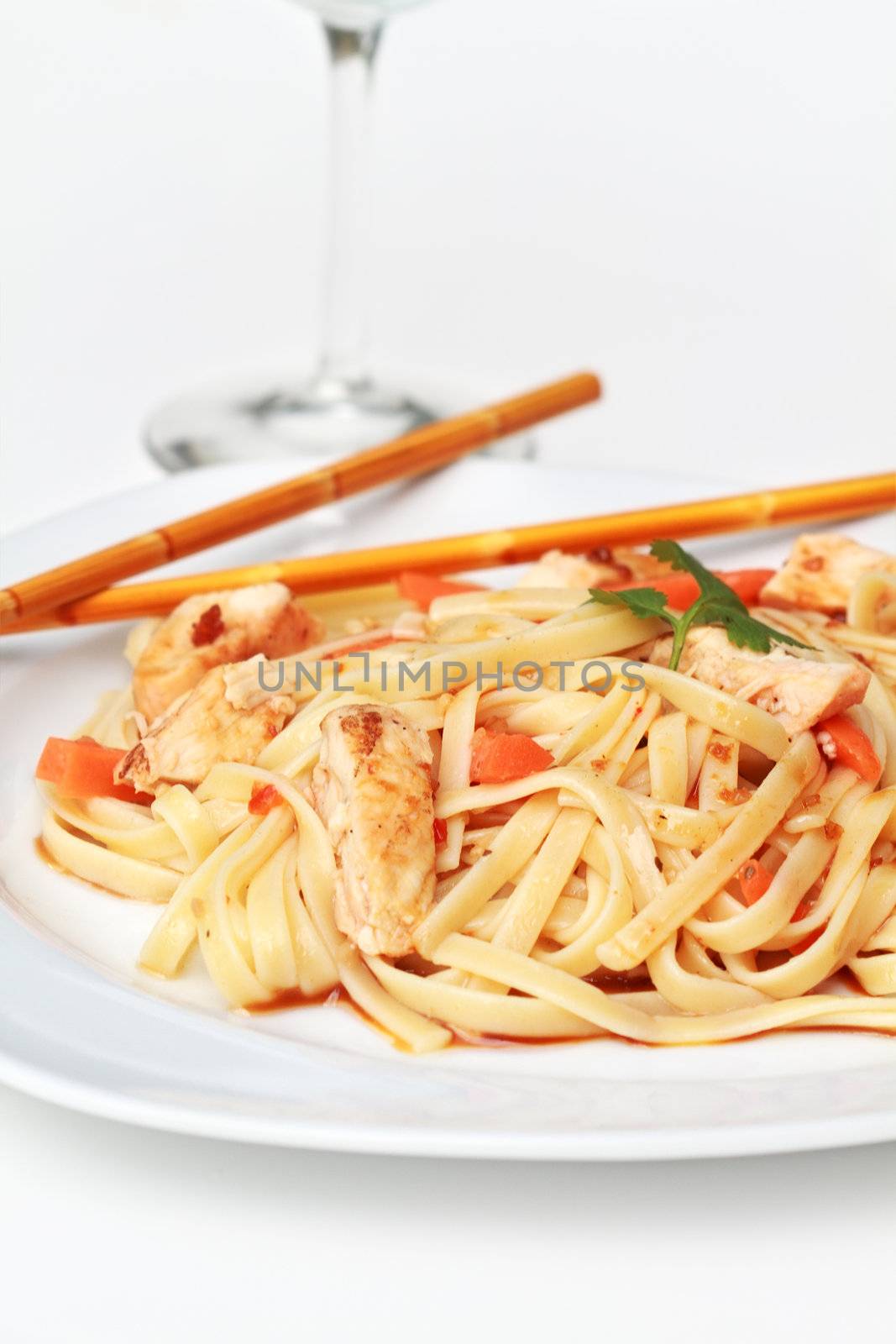 Plate of delicious healthy Asian Chicken Pasta with grilled chicken and carrots. 