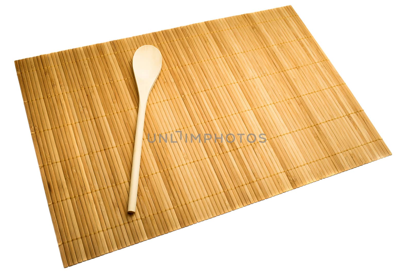 Wooden spoon on mat of bamboo, isolated on white.