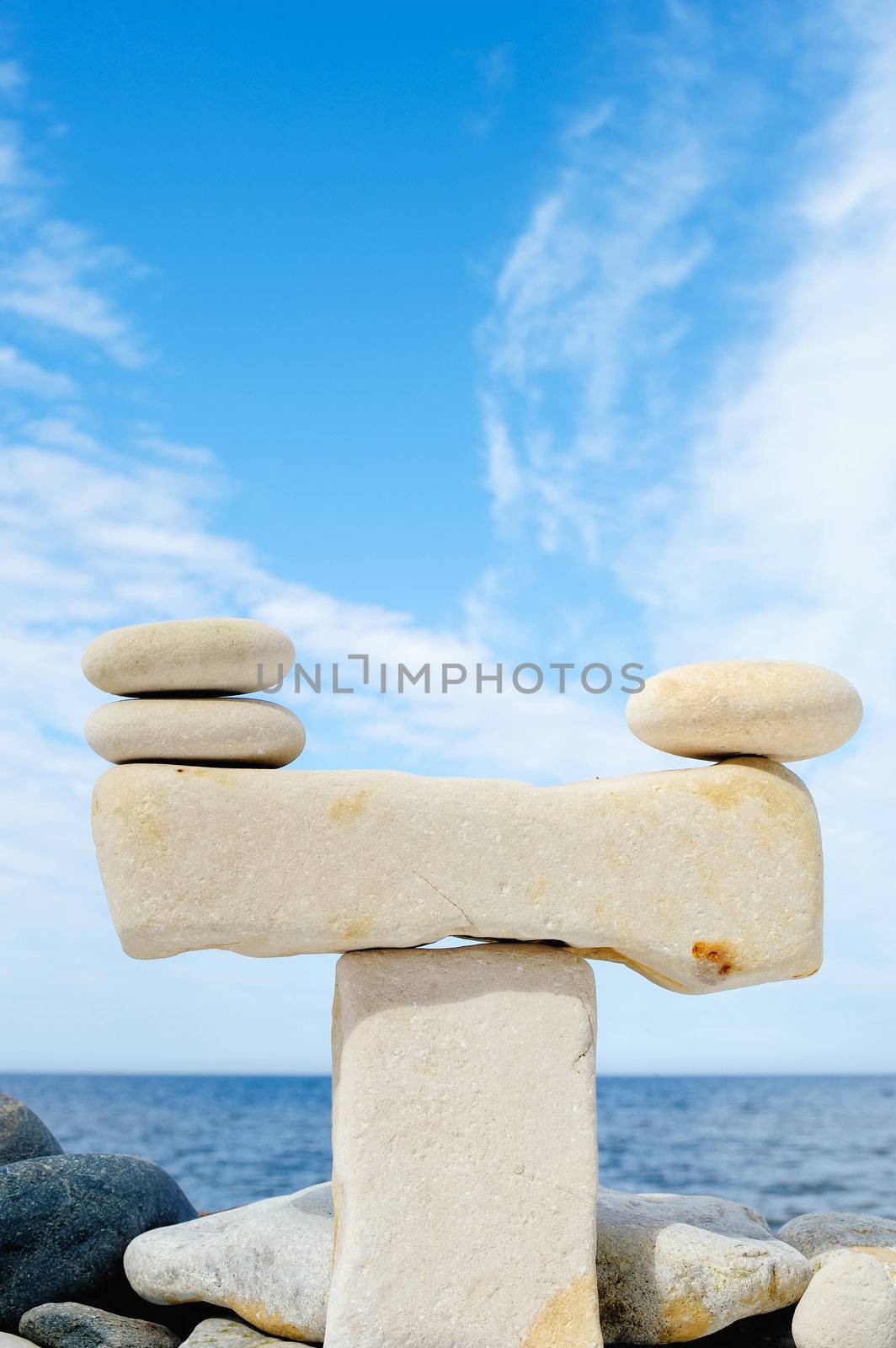 Pile of pebbles in the balance on the seacoast