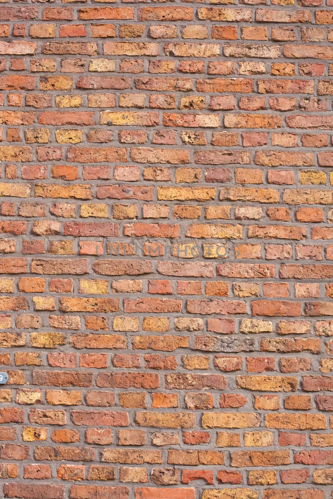 Background texture pattern of exterior wall made of red bricks.