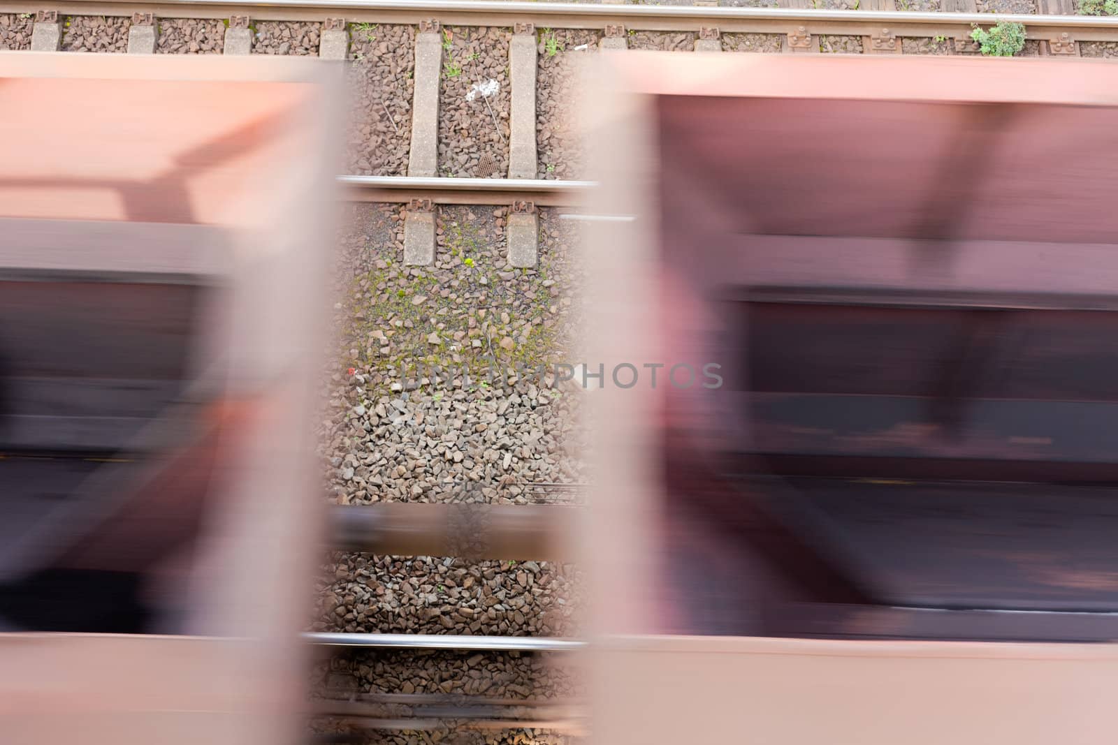 Fast moving freight cars (motion blur) of cargo train.