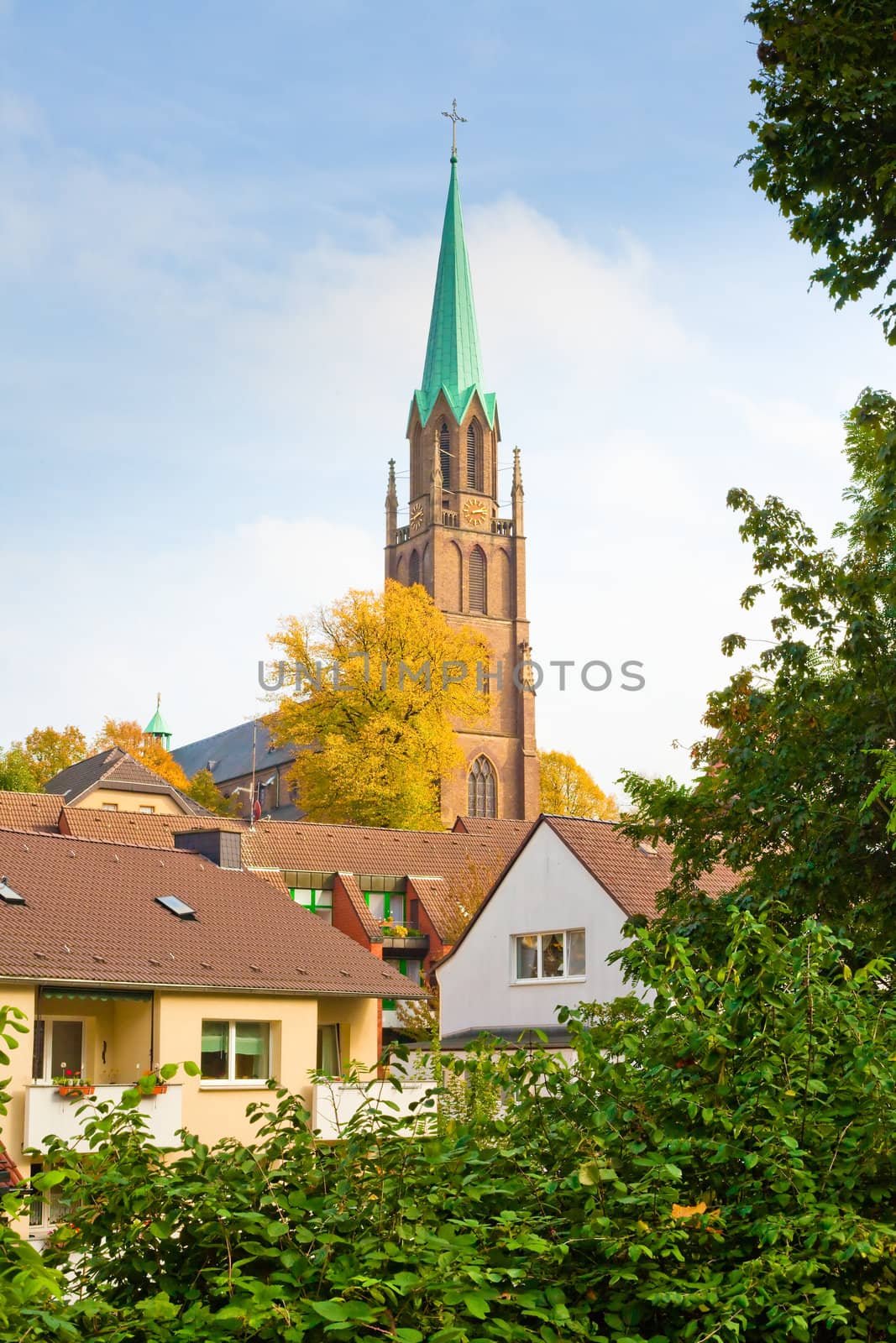 Brick church towering over houses, Essen-Borbeck, Germany.