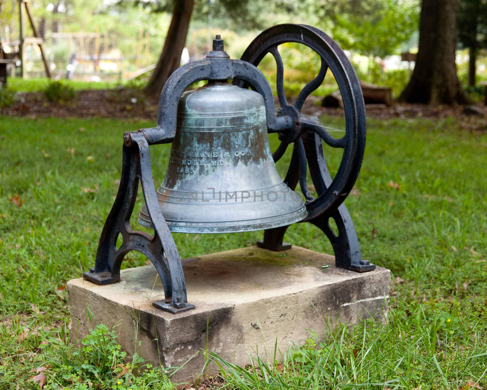 Old bell from church tower in frame in garden