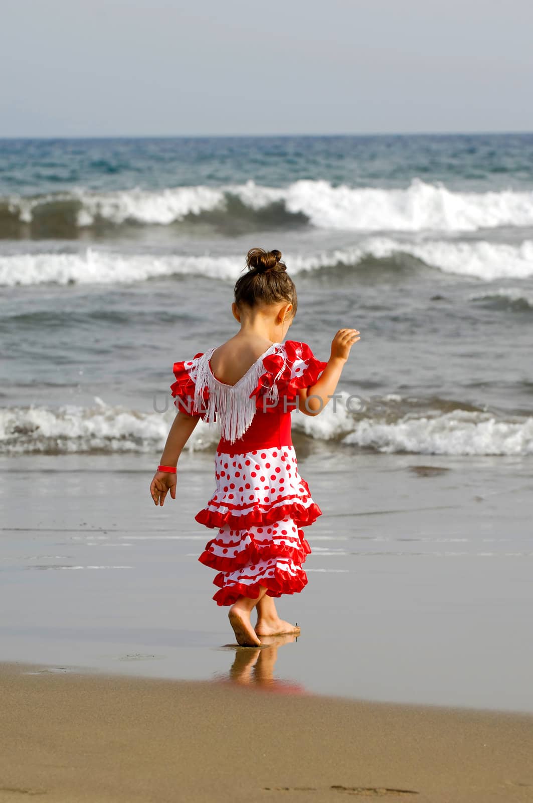 Child is walking at the beach