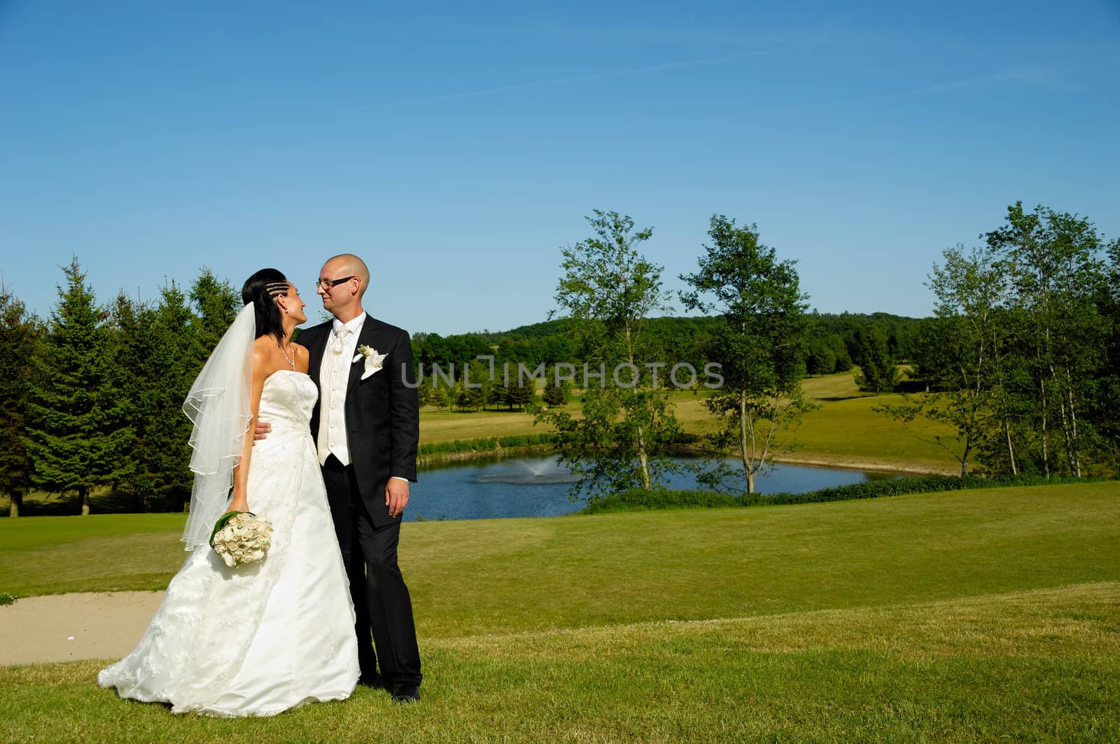 Wedding couple is looking at eachother.