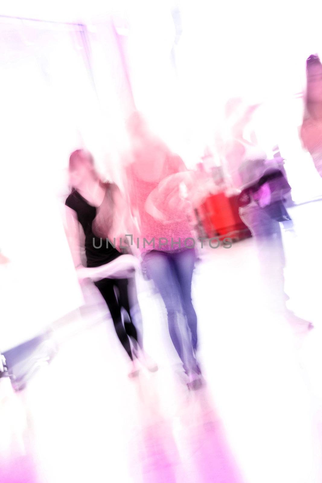 blurred unrecognizable people in motion in a shopping mall