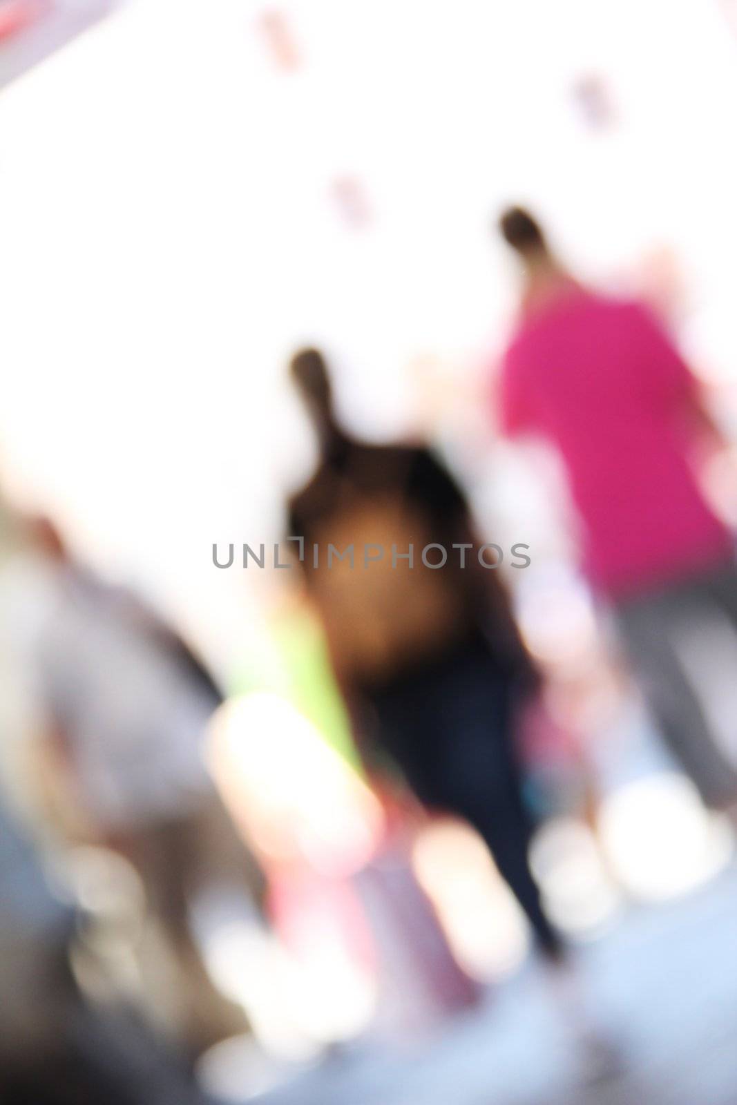 blurred unrecognizable people in motion in a shopping mall