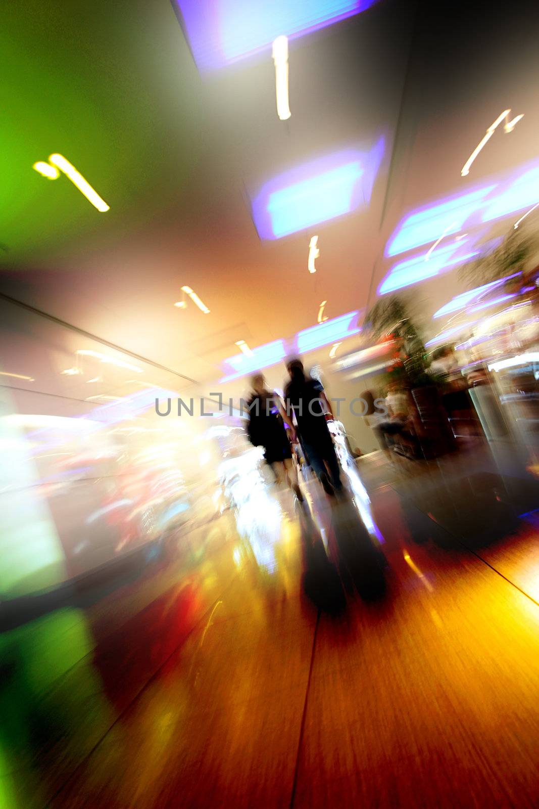 blurred unrecognizable people in motion in a shopping mall