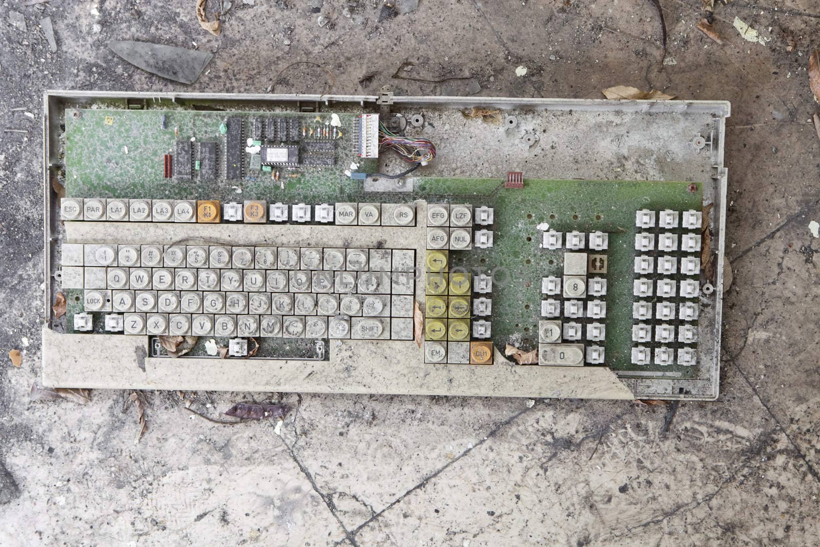 A very old broken computer keyboard covered in dust