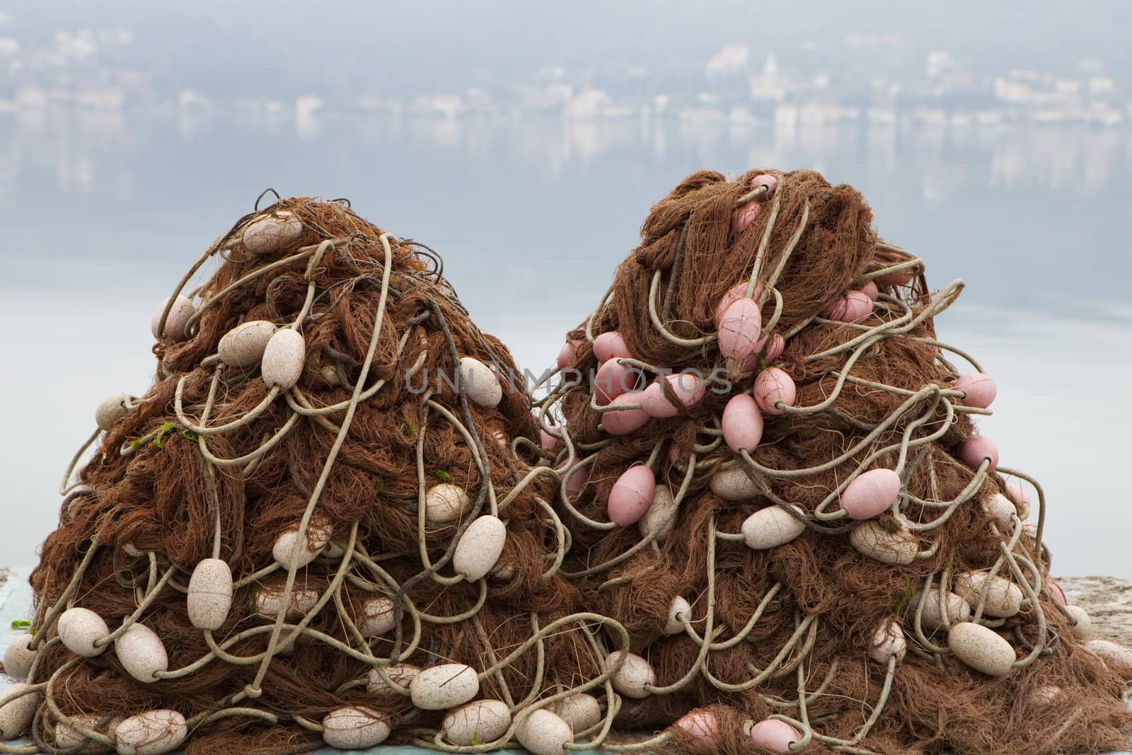 Two piles of fishing nets and floats