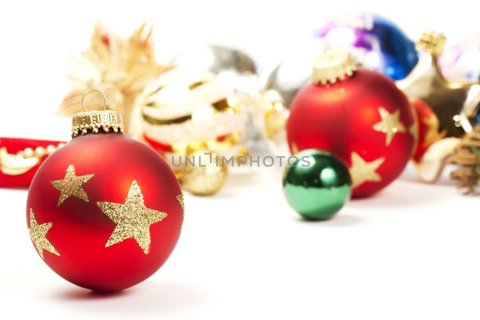 red dull christmas ball in front of colorful christmas ornaments