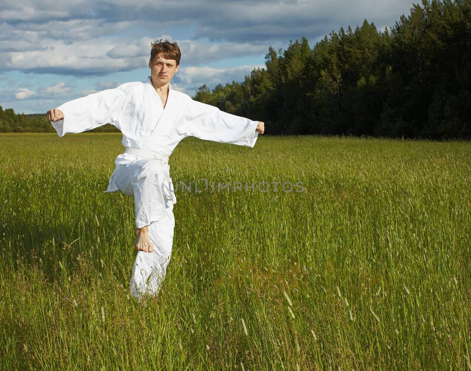 The young man goes in for sports in the open air