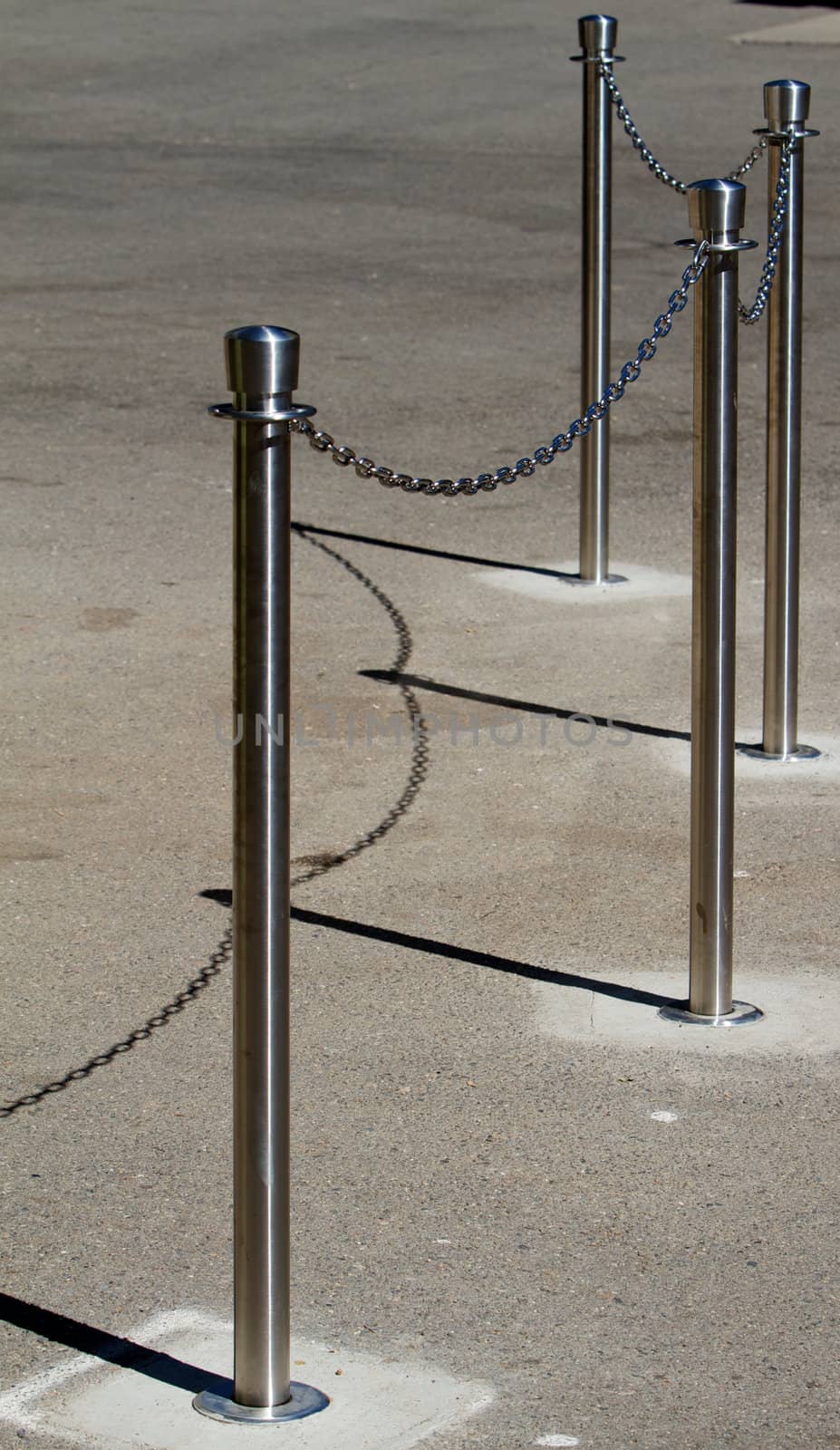 Stainless steel cue chain and posts on concrete