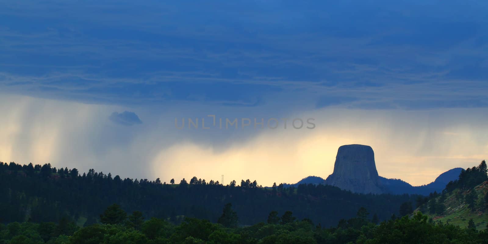 Evening rainstorm against sunset over Devils Tower National Monument in northeastern Wyoming.