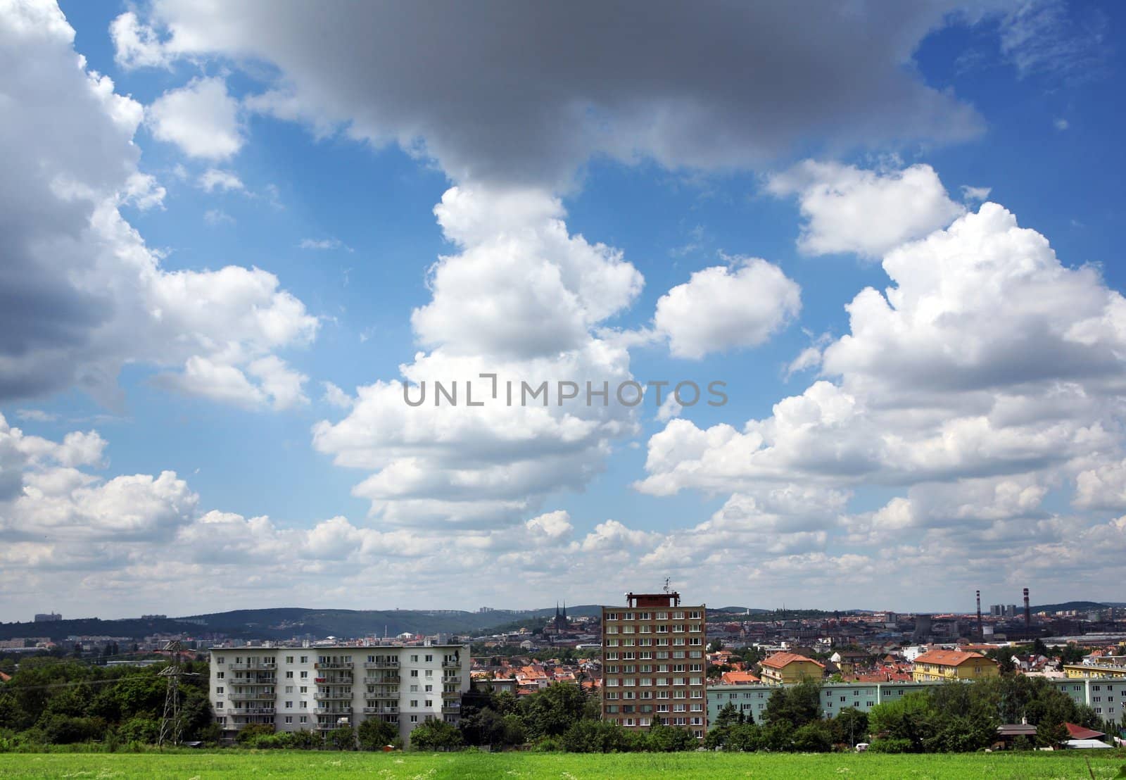Landscape with city and dramatic cloudy sky
