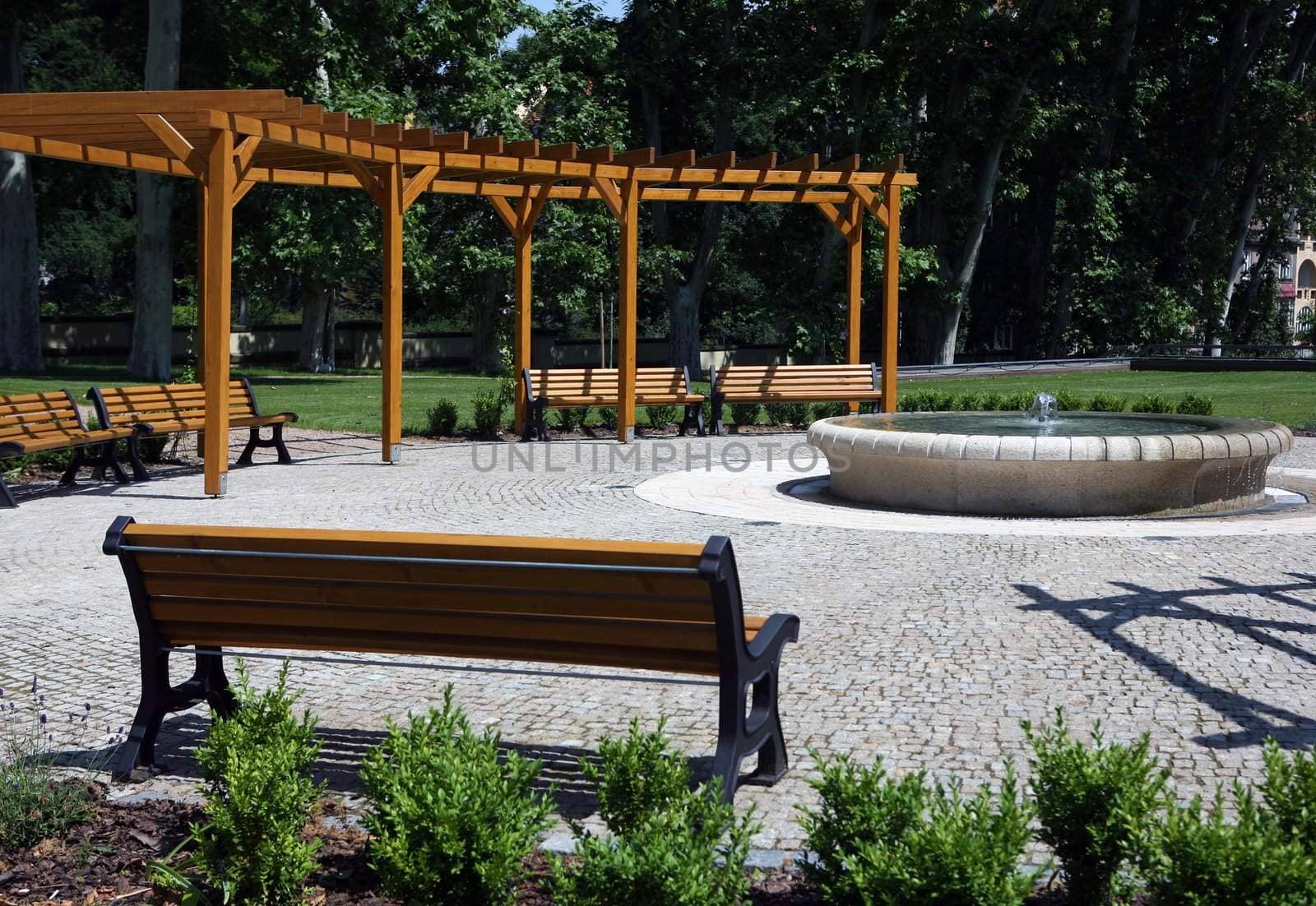 Garden with small fountain and benches around