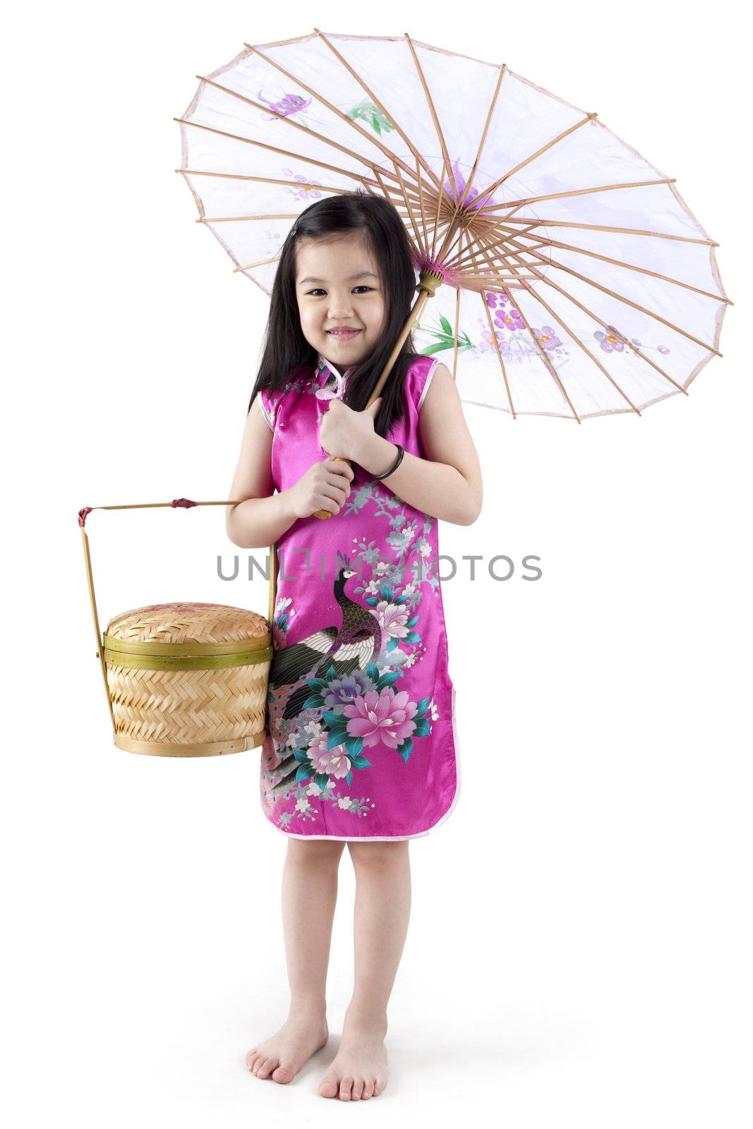 Little oriental girl in traditional Chinese dress cheongsam with umbrella and basket