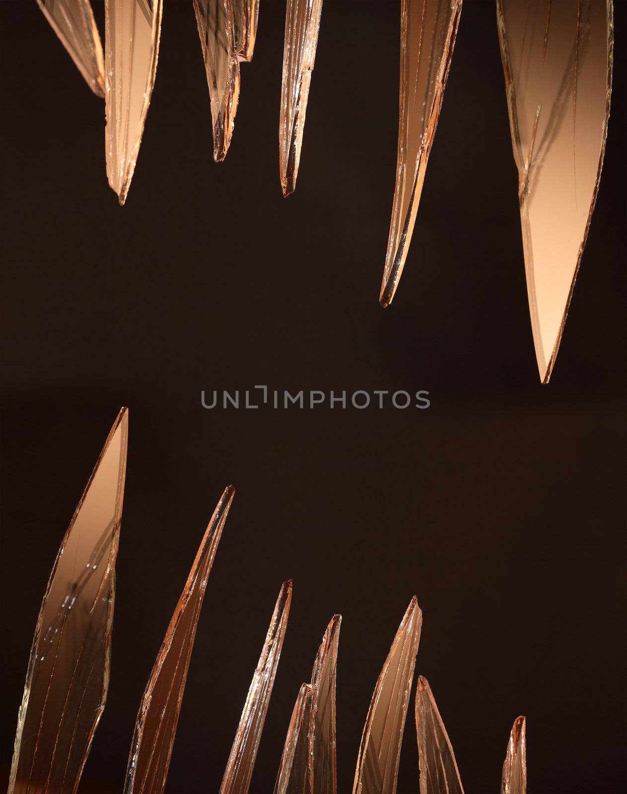 Closeup of few pieces of cracked glass on dark background