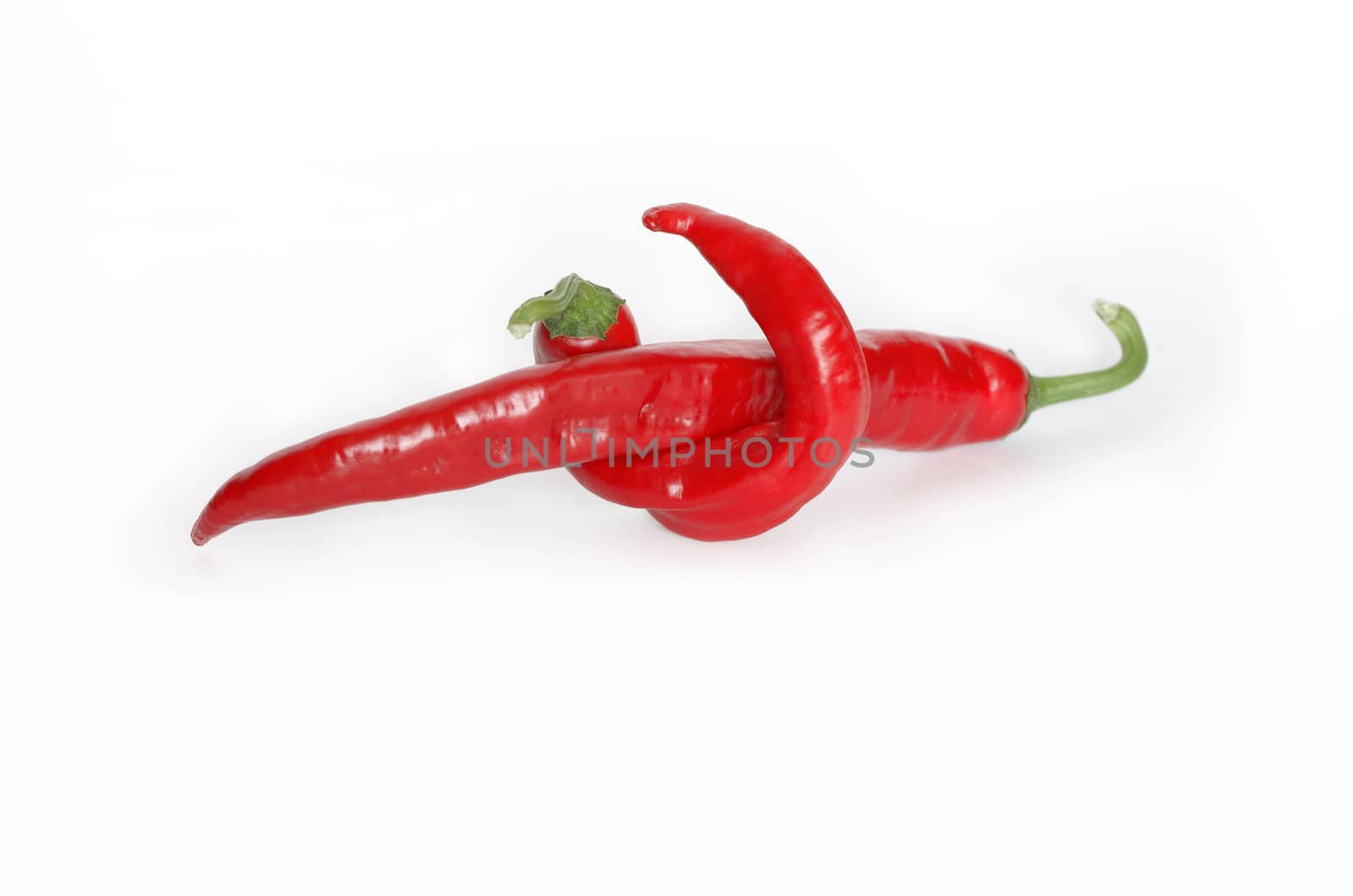 Two red chili peppers isolated on white background. Clipping path is included