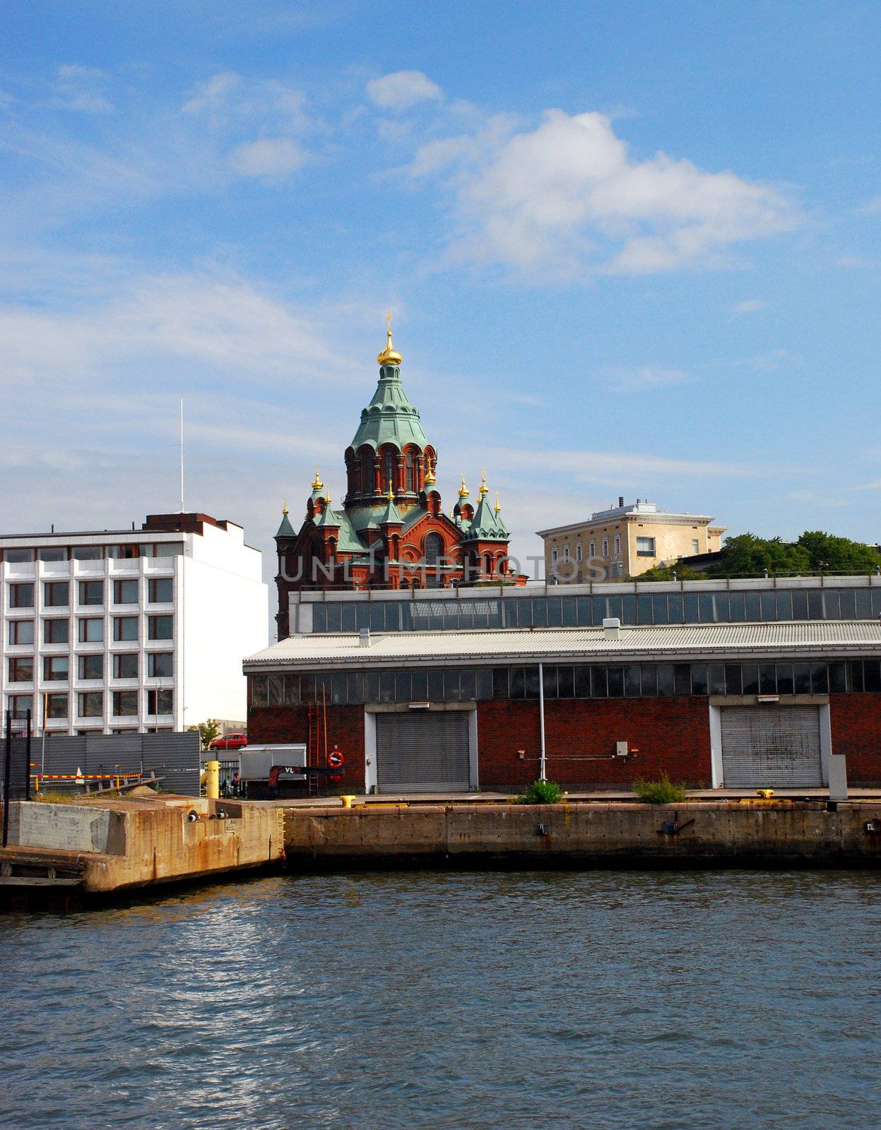 Uspenski Cathedral, seen from the see, with in the foreground the industrial part of helsinki, the harbour.
This cathedral is an orthodox cathedral, of the finish capital,  helsinki. It was built on the order of alexander II of russia during the nineteeth century.