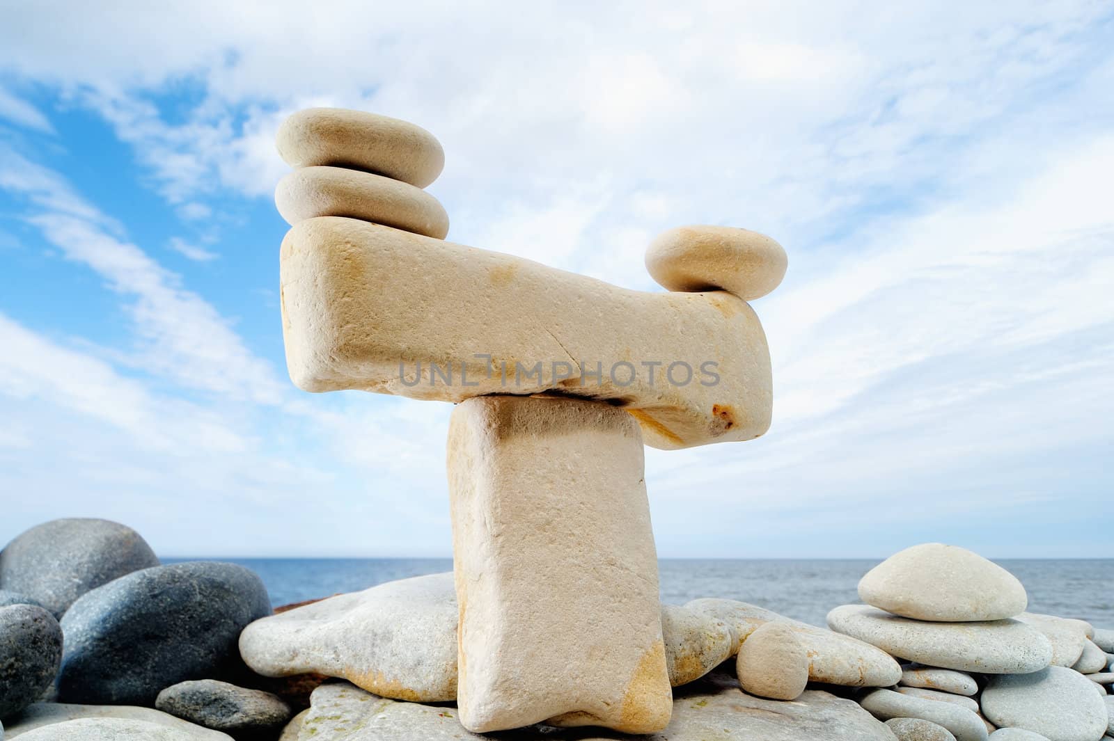Pile of pebbles in the balance on the seacoast