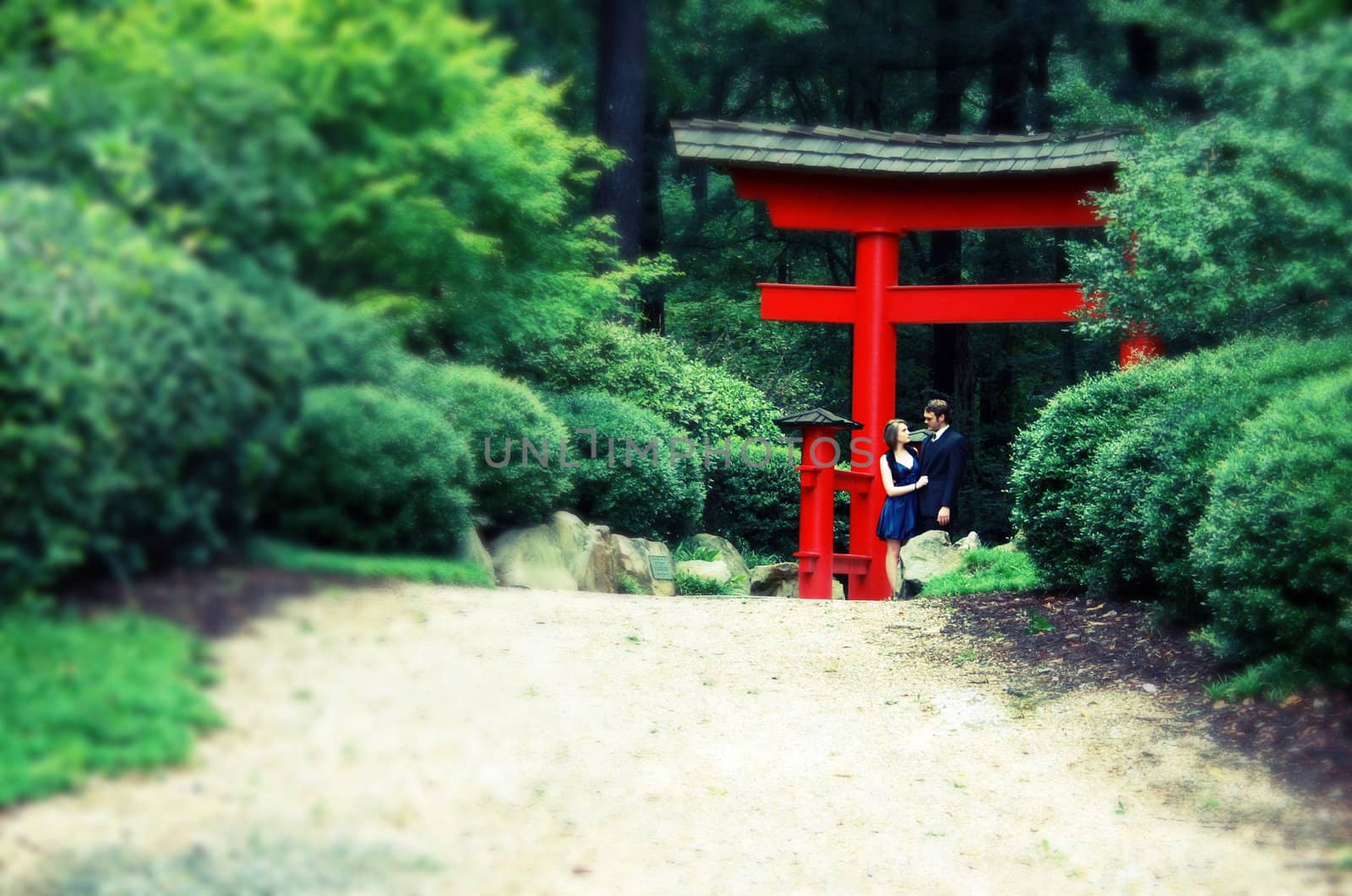 Man, Woman under red Asian gate, intentional blur, cross process by mahnken