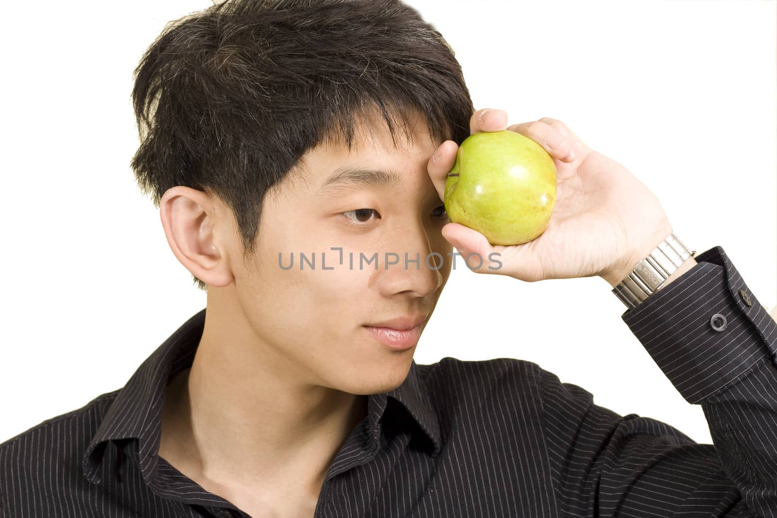 Young Asian man eating apple by cozyta