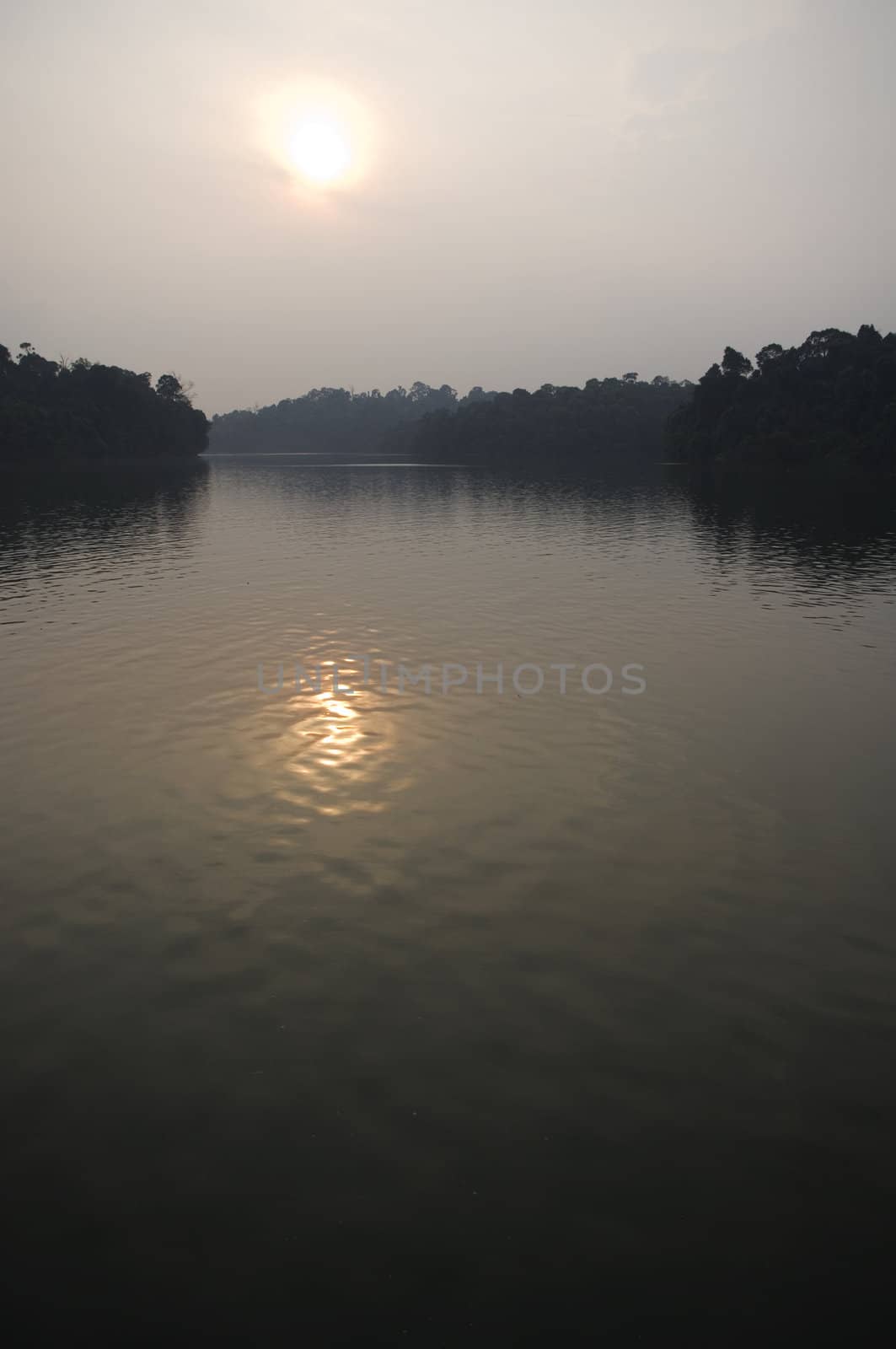 sun reflection on a lake, in a hazy day