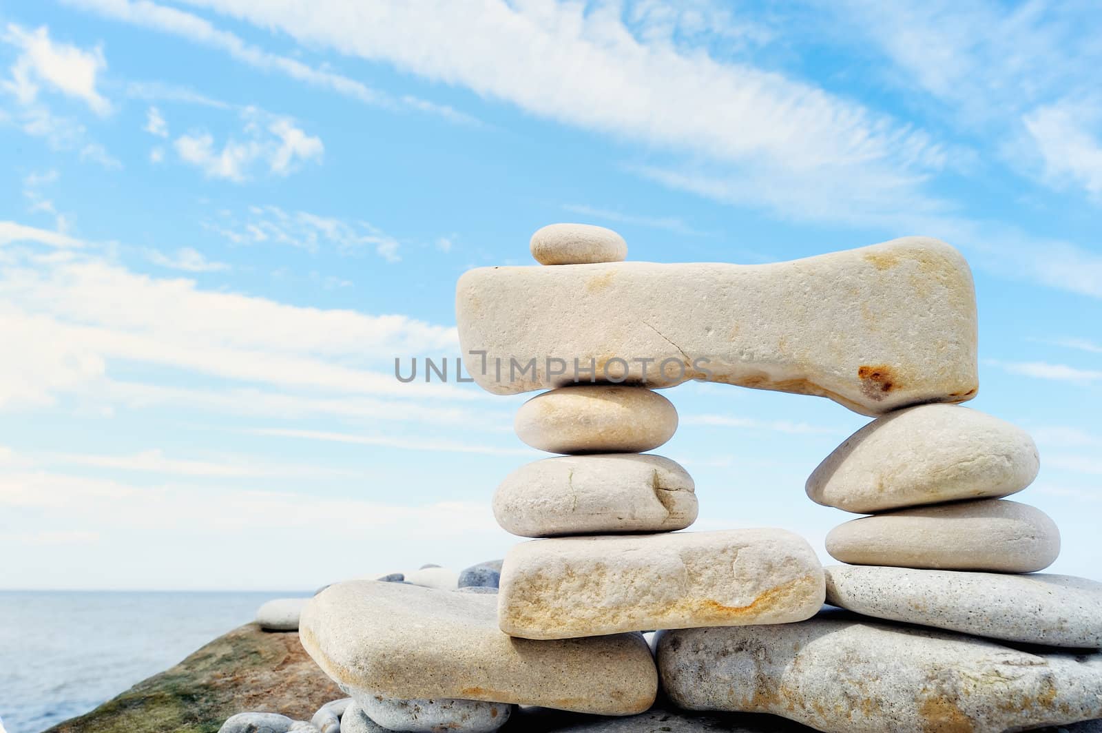 Small pebbles are connected with a large stone on seacoast