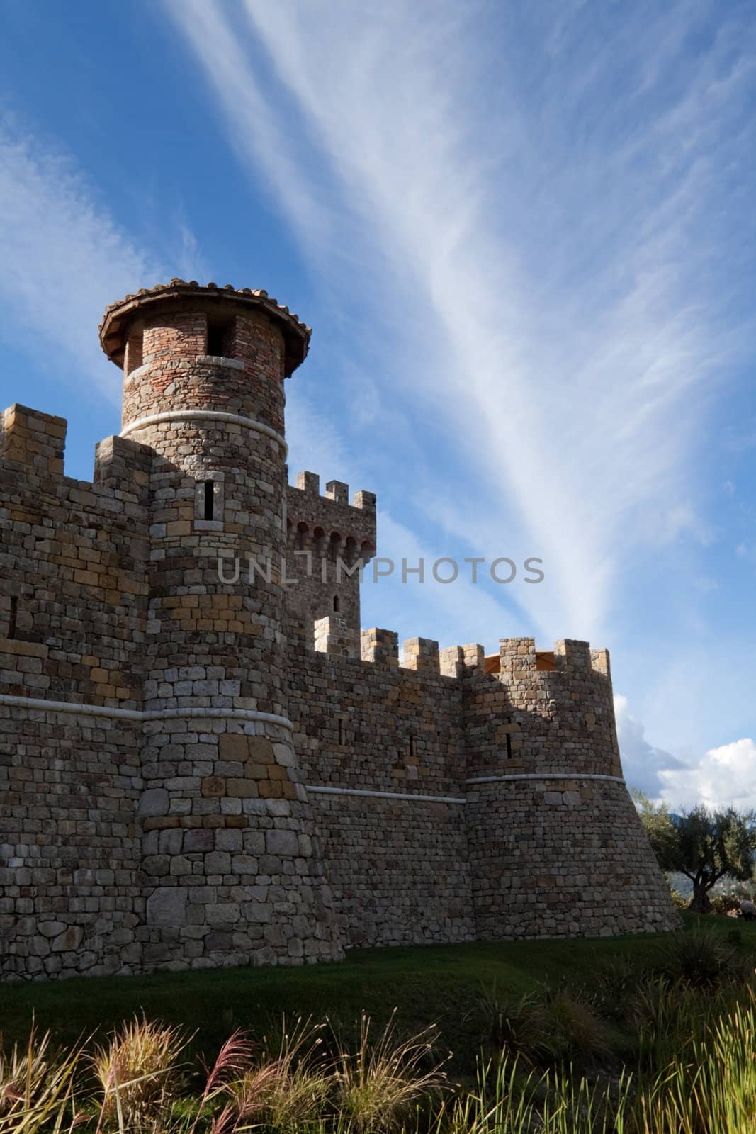 A stone castle with hilly mountains in the background