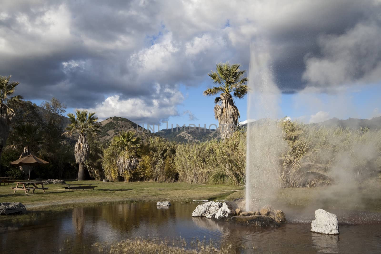 A natural geyser shooting water out of the ground and into the air