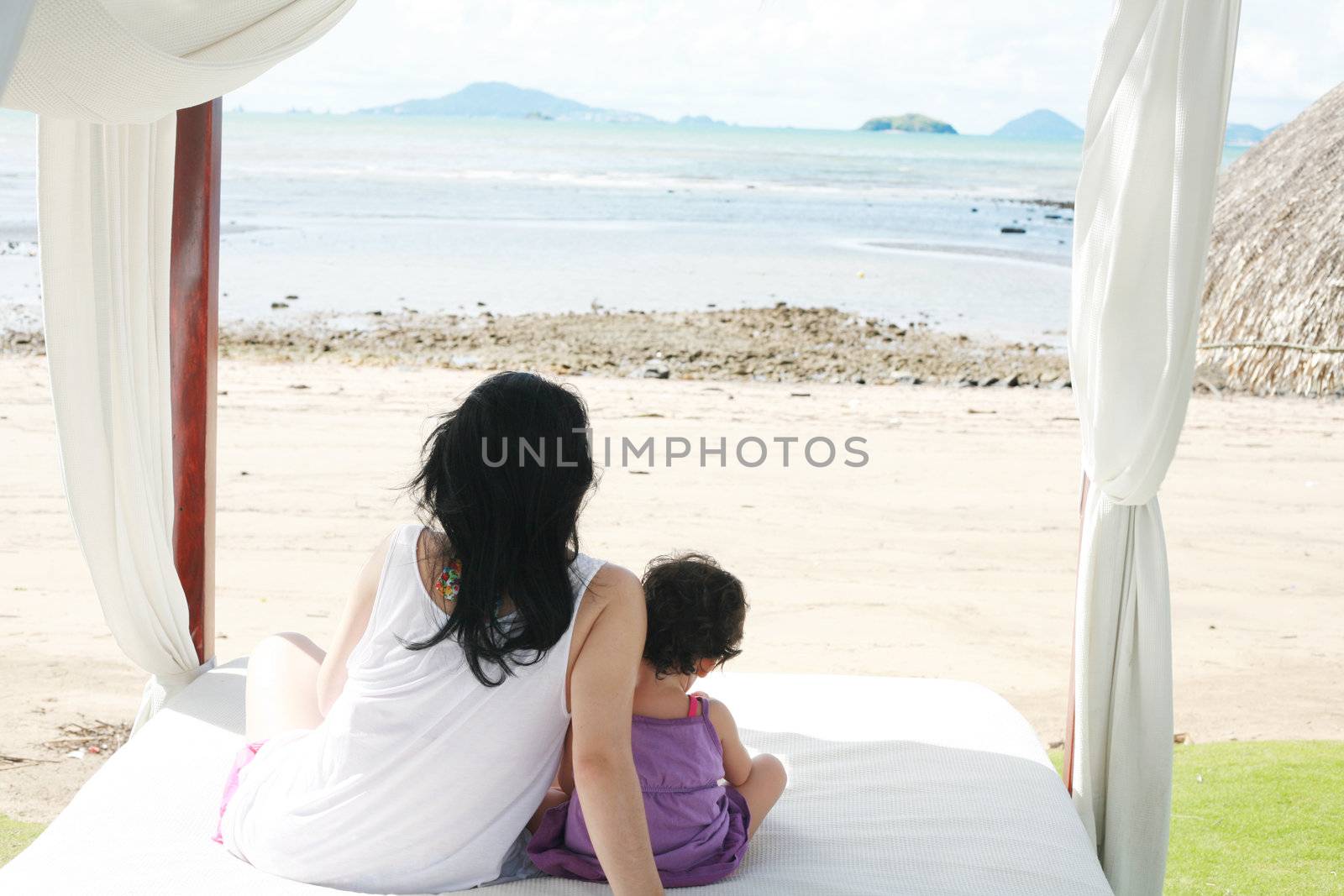 mom with a child watching the beach on the bed by dacasdo