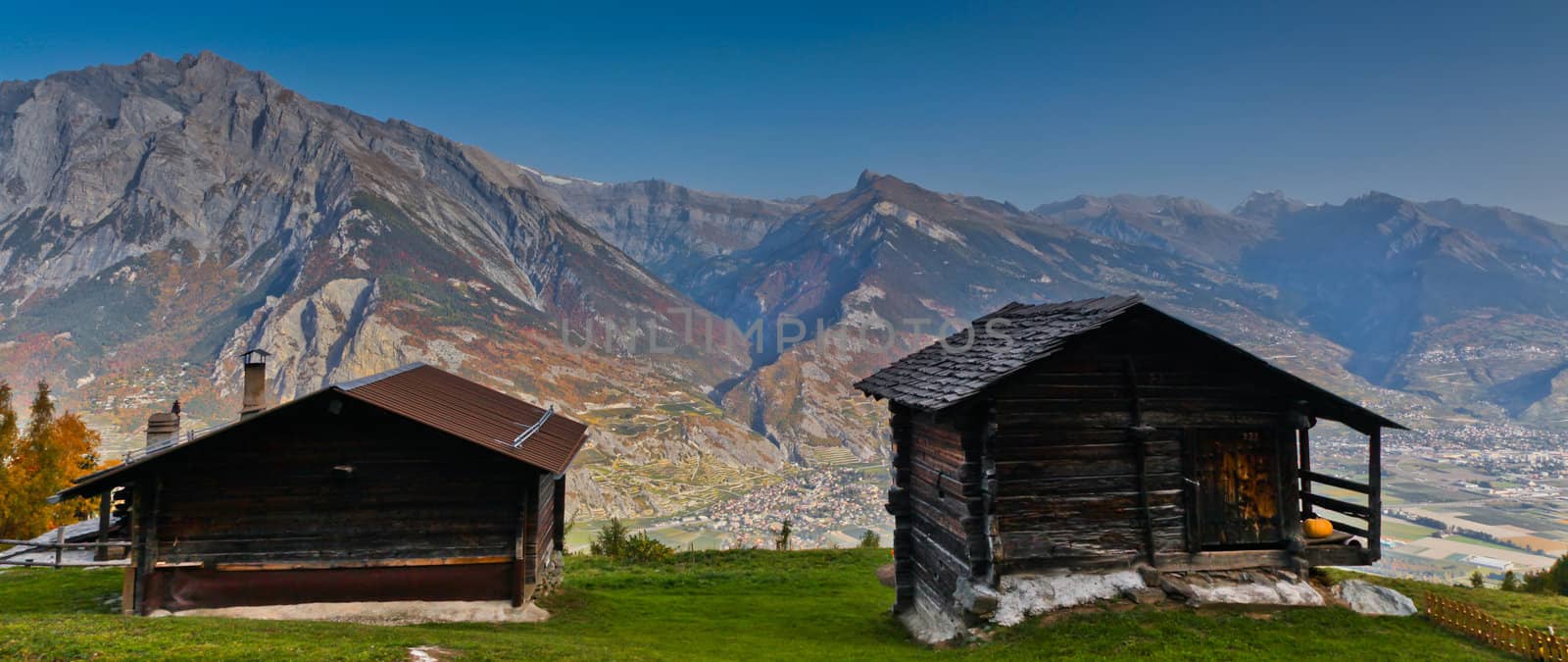 A couple of huts with Swiss Alps as background