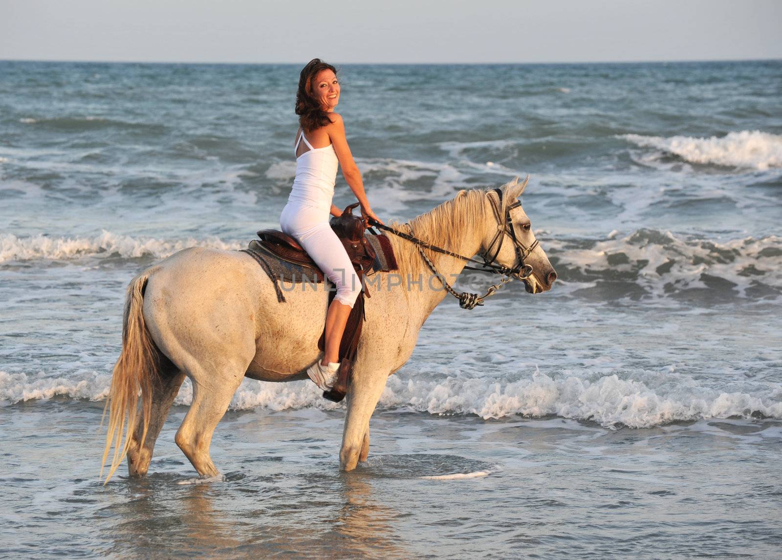 smiling riding young woman in the sea