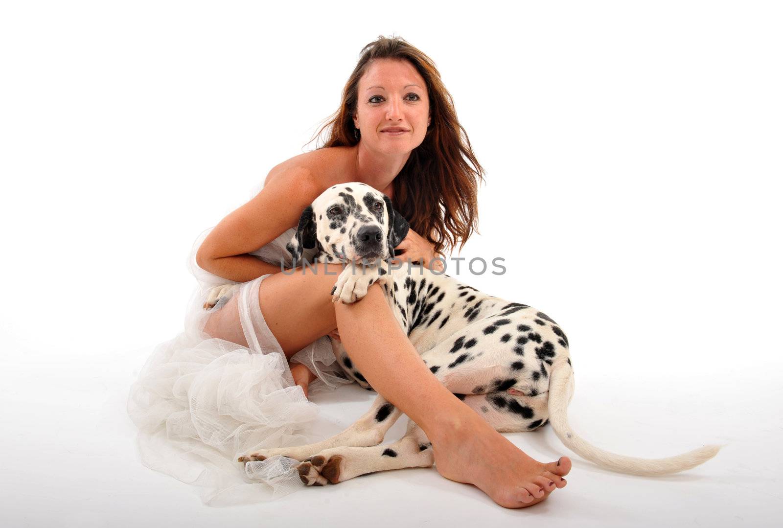 young woman in wedding dress with her purebred dalmatian