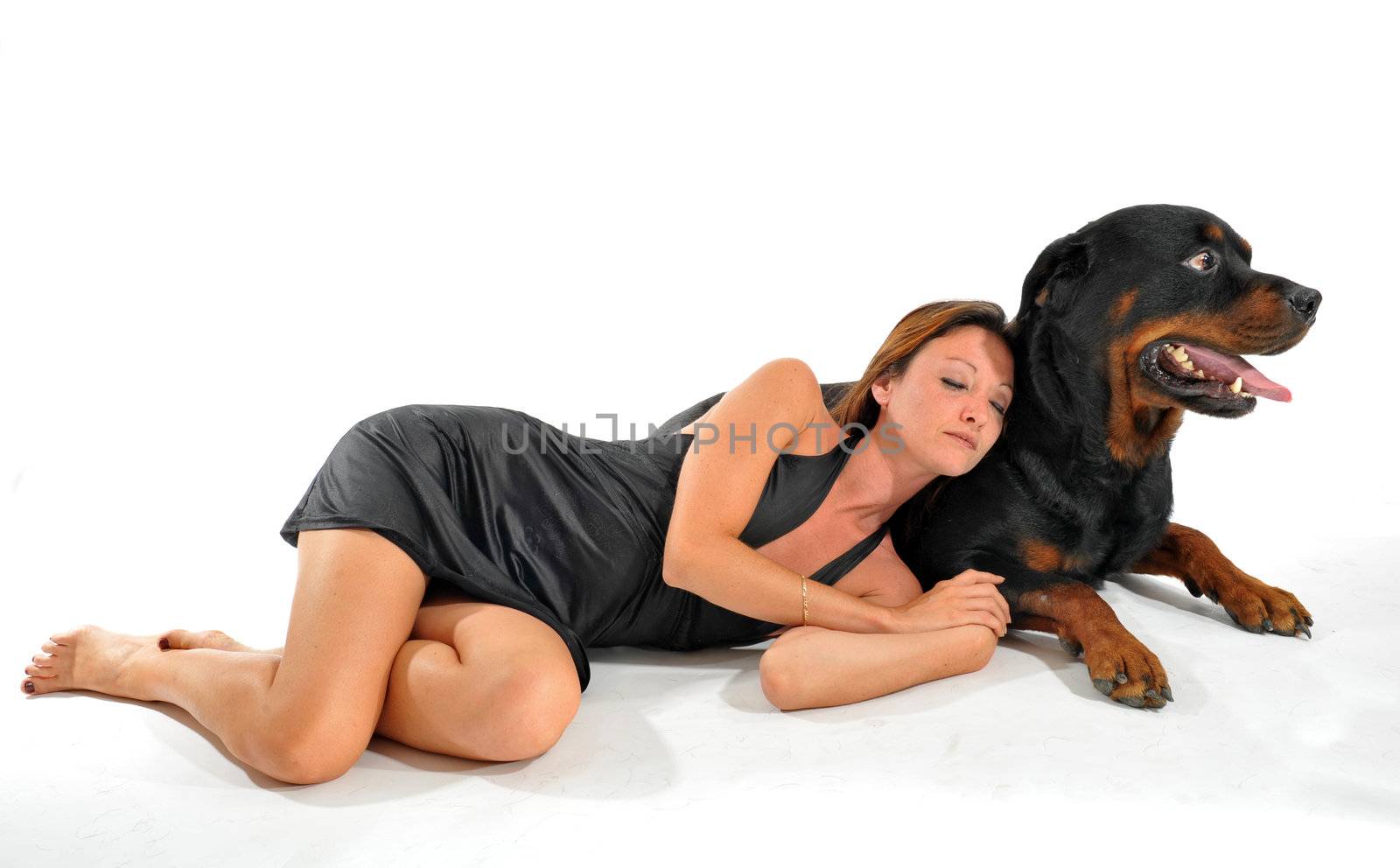 sleeping young woman and her purebred dog rottweiler