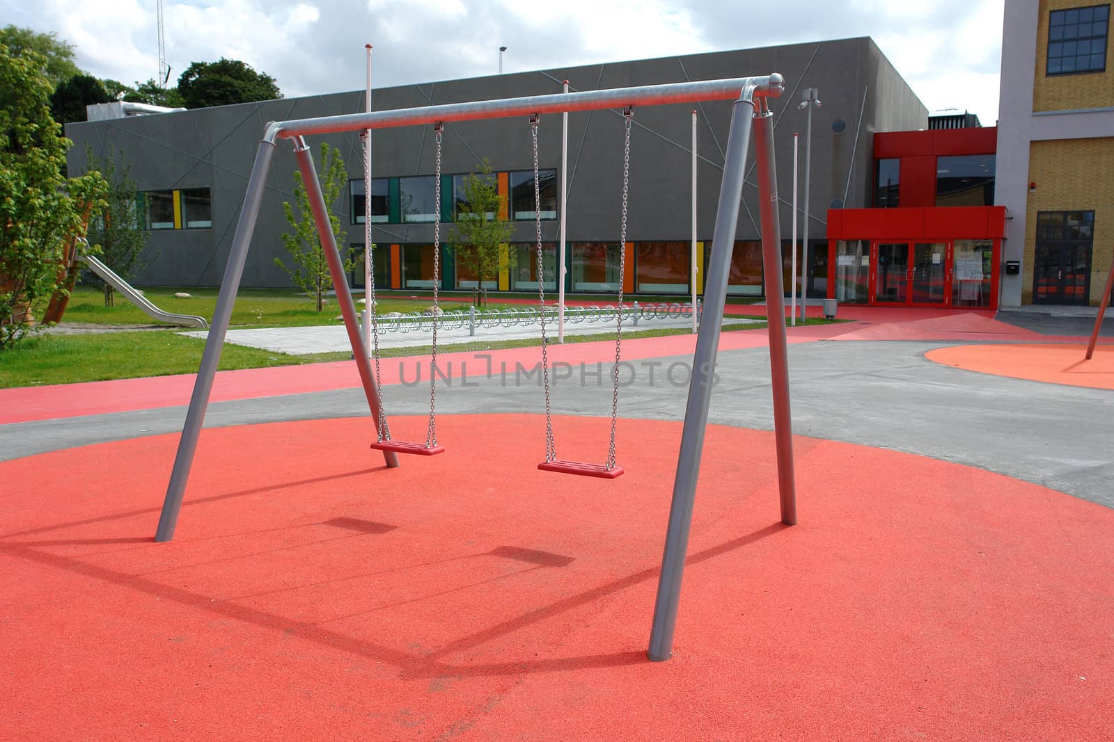 Modern design metal swing in a new city playground                              
