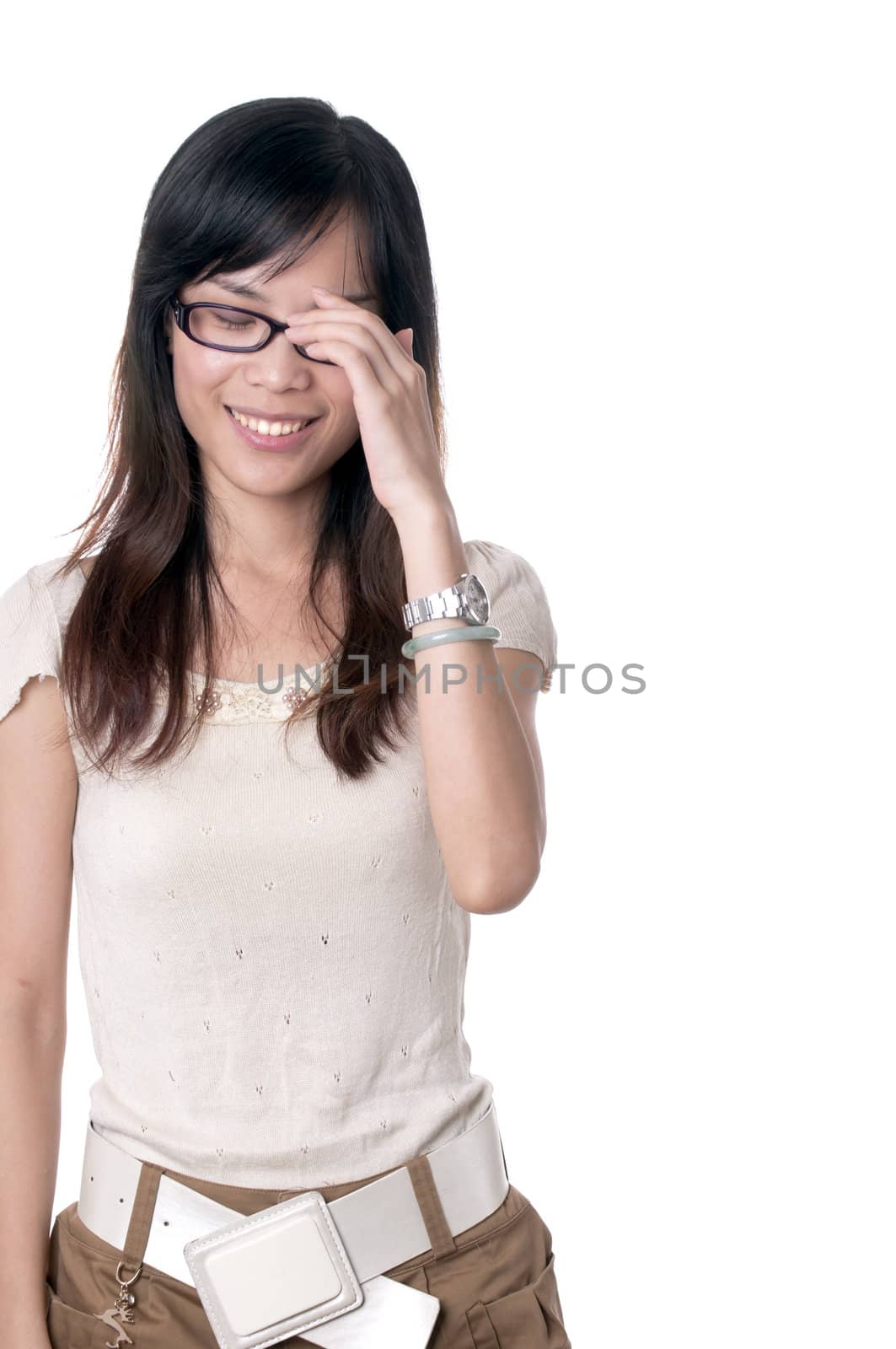 A shy girl in glasses is smiling with eyes closed isolated on white