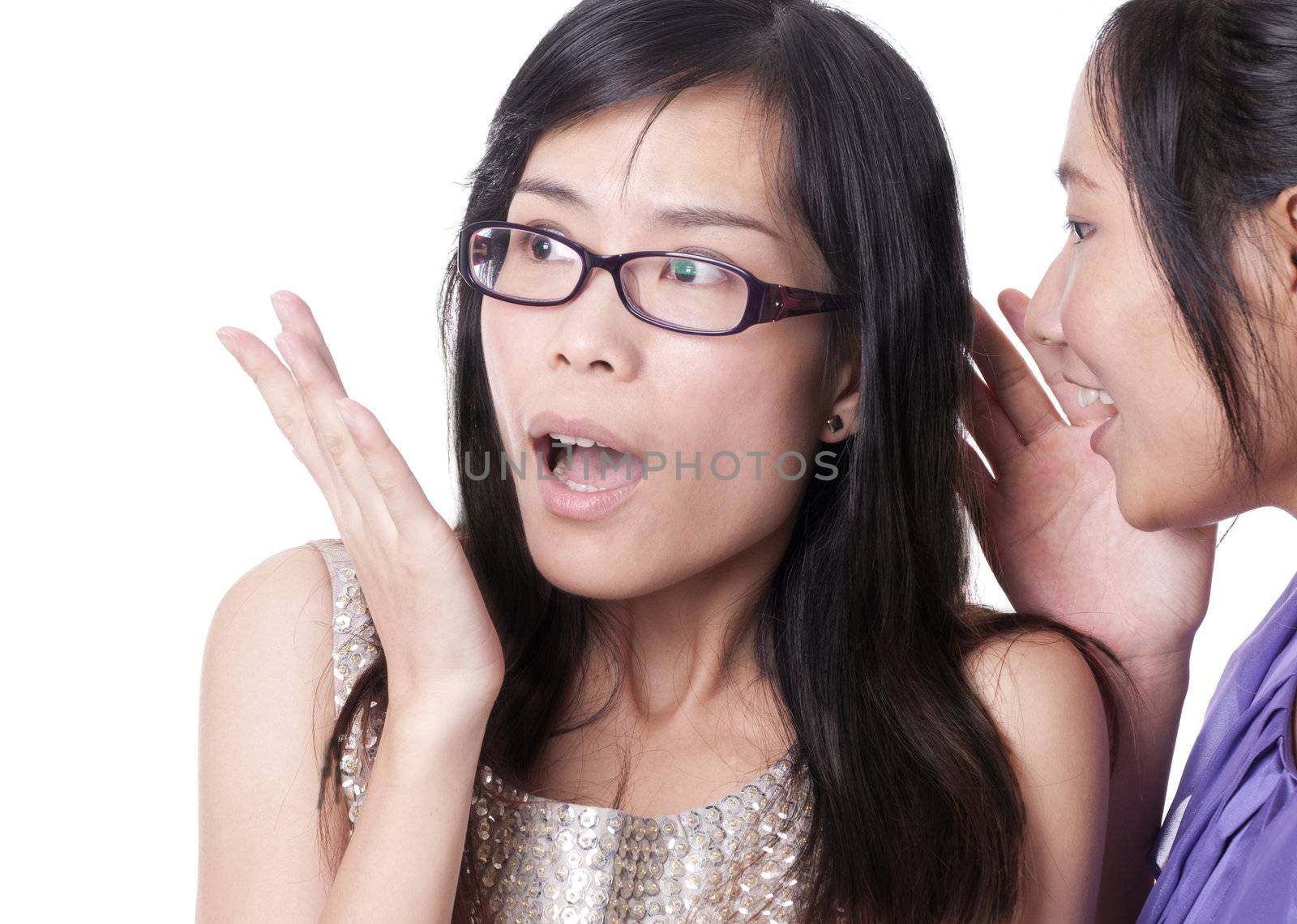 Girl telling a secret to another - gossip isolated over a white background