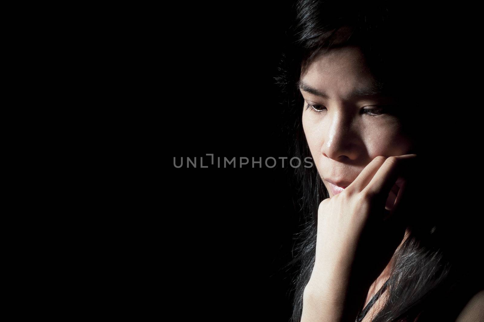 Beautiful Asian girl looking away in deep thought