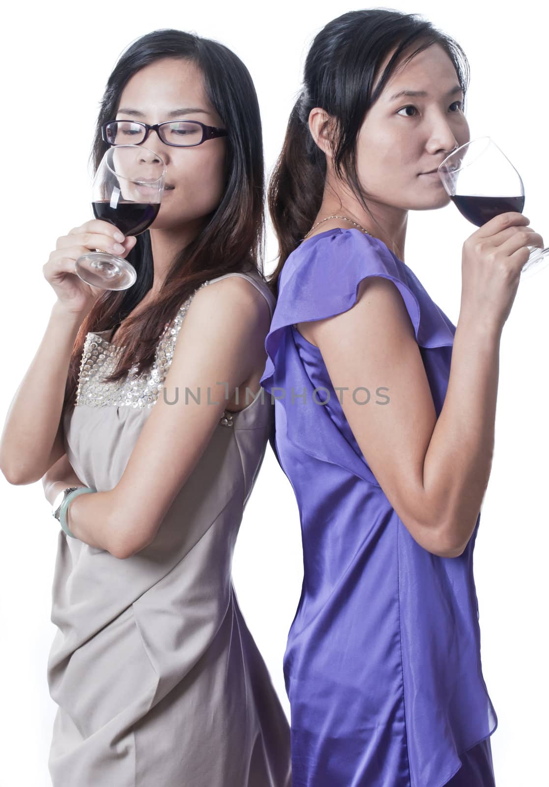 Two women next to each other in a bar having a drink