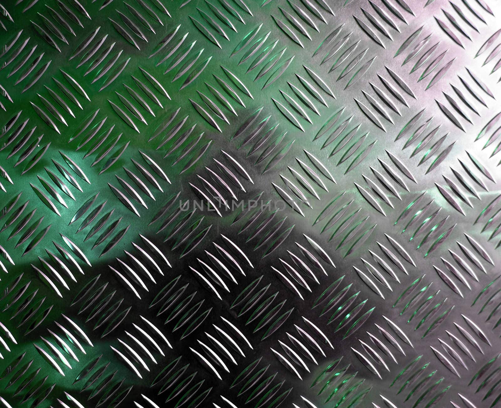 Diamond steel plate industrial iron metal background with green light reflection