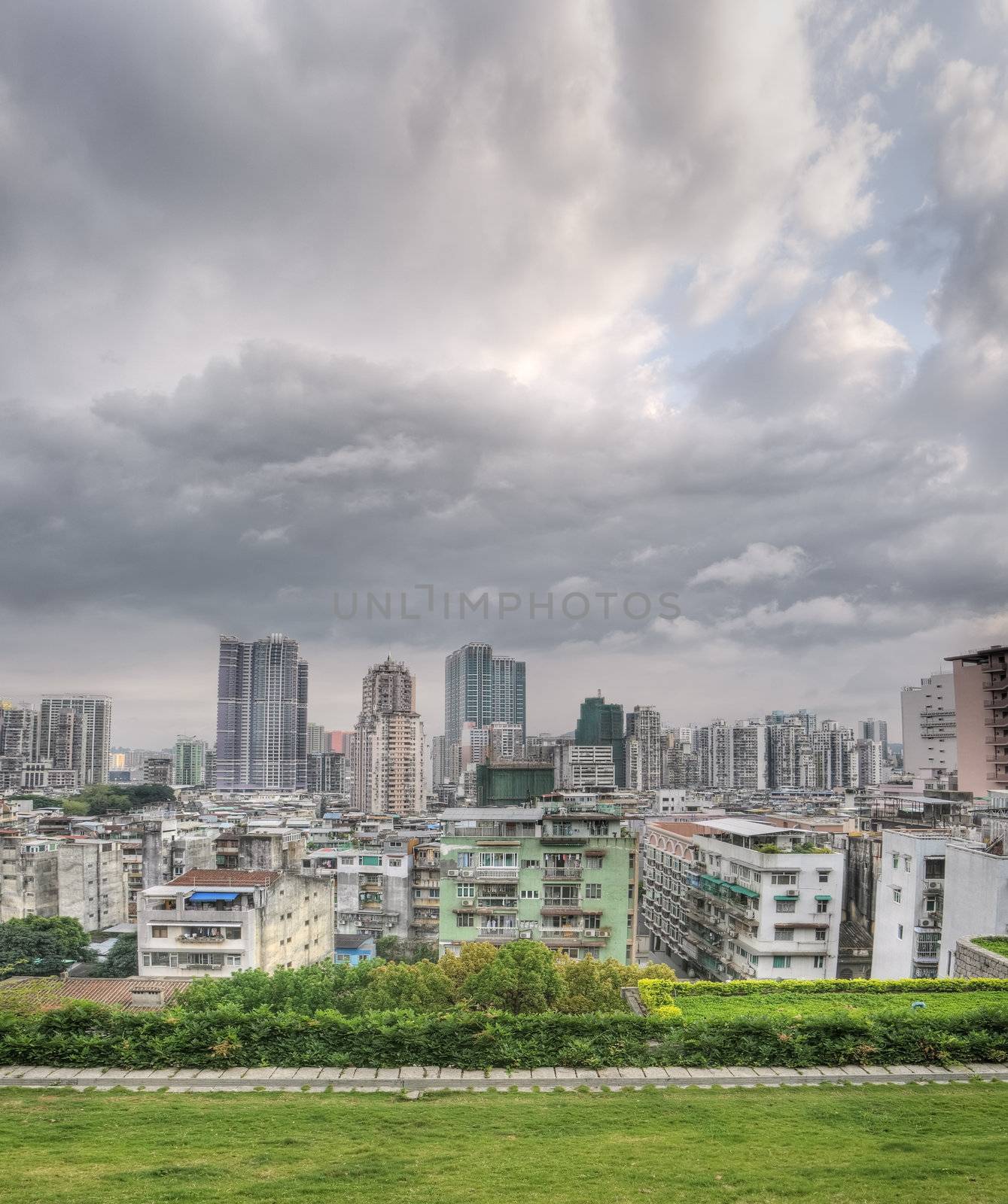 City skyline in Macao with buildings and skyscrapers under clouds in sky in Macau, China.
