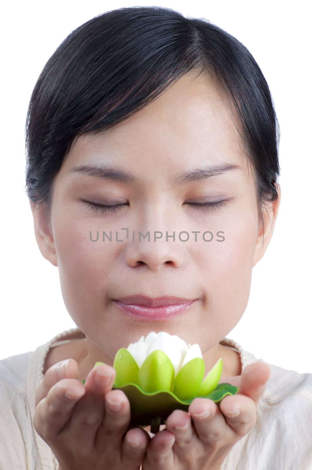 Asian woman holding and smelling beautiful white  lily flower with spa concept isolated