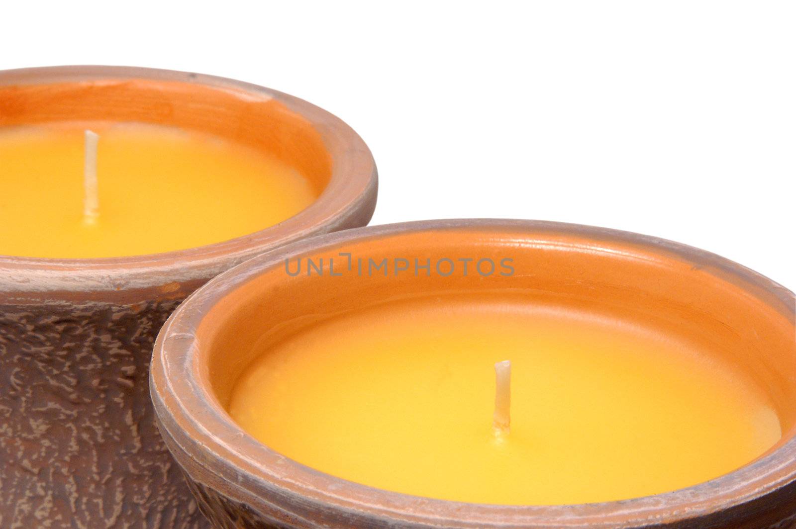 two unlit Citronella candles isolated on white and tightly cropped
