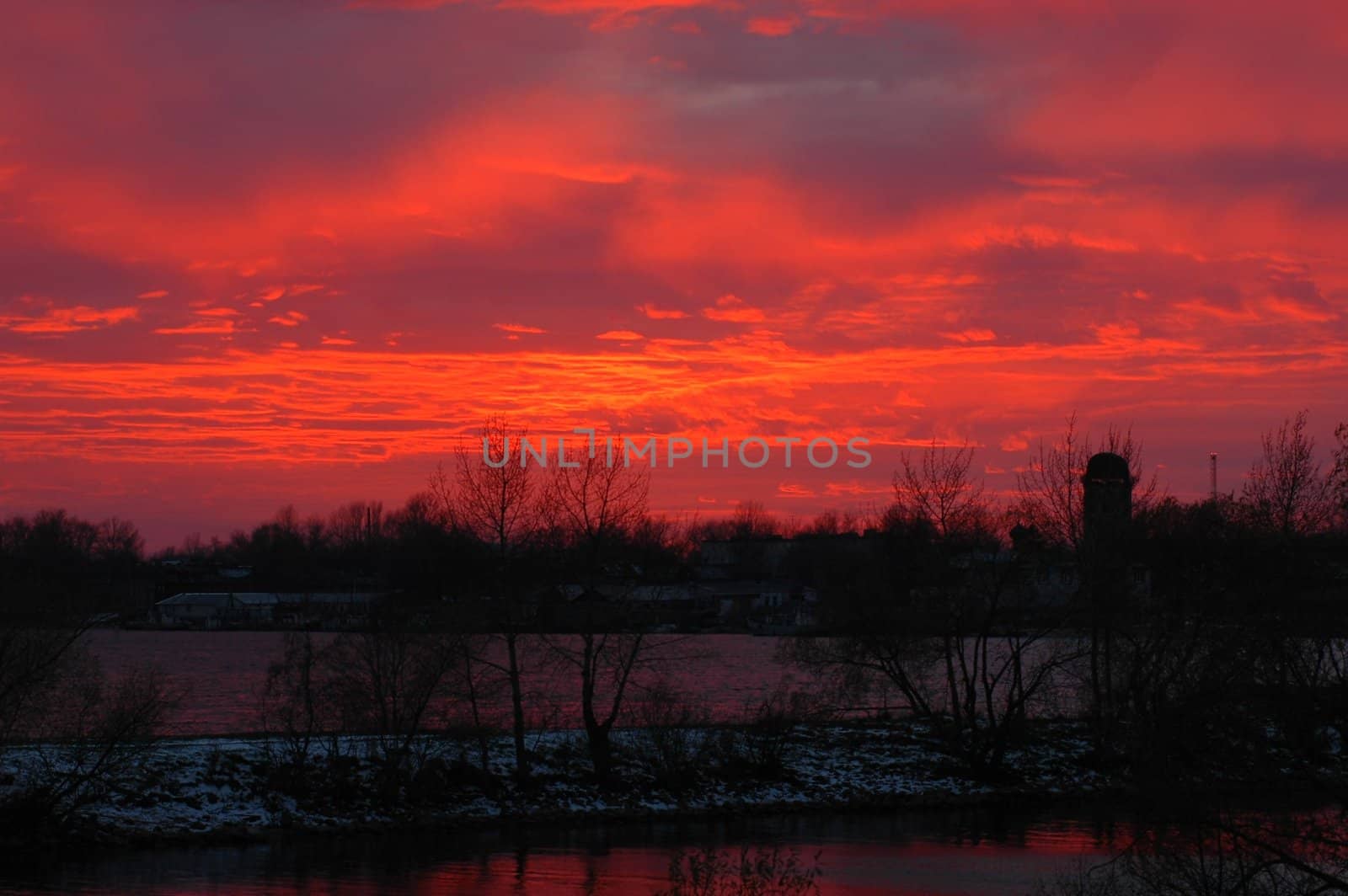 Blood-red decline on Volhov River. The come sun has painted blood-red color the sky and clouds over Volhov River