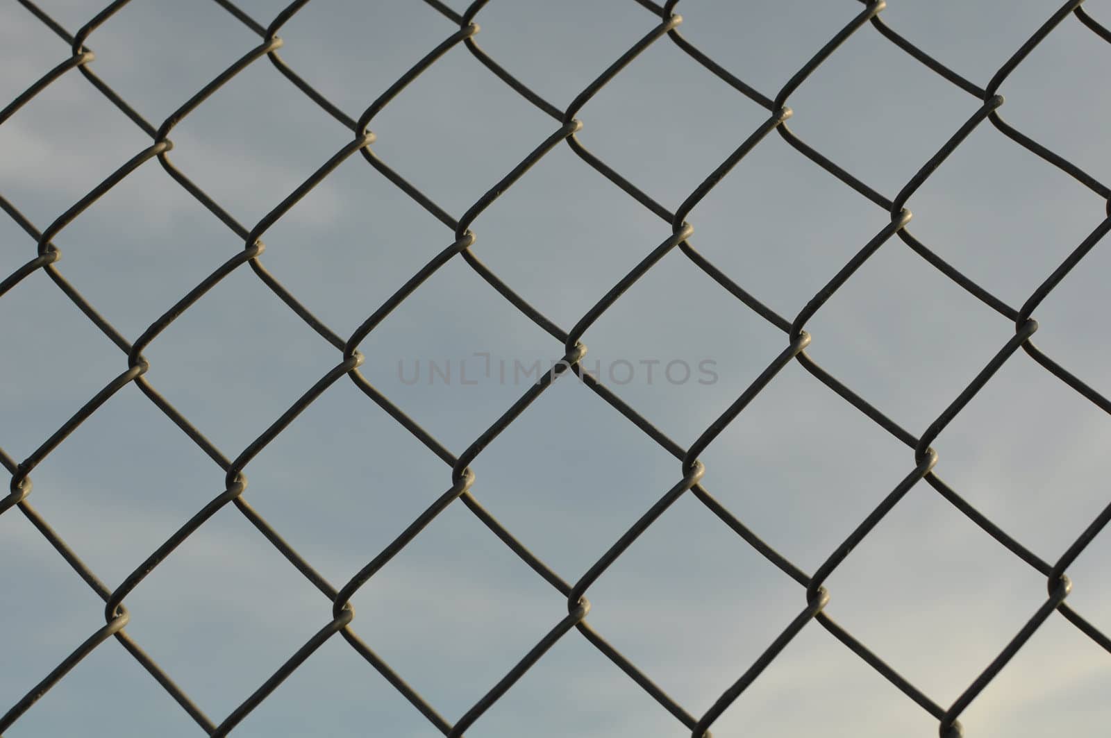 Chain Link Fence Background with Blue Sky