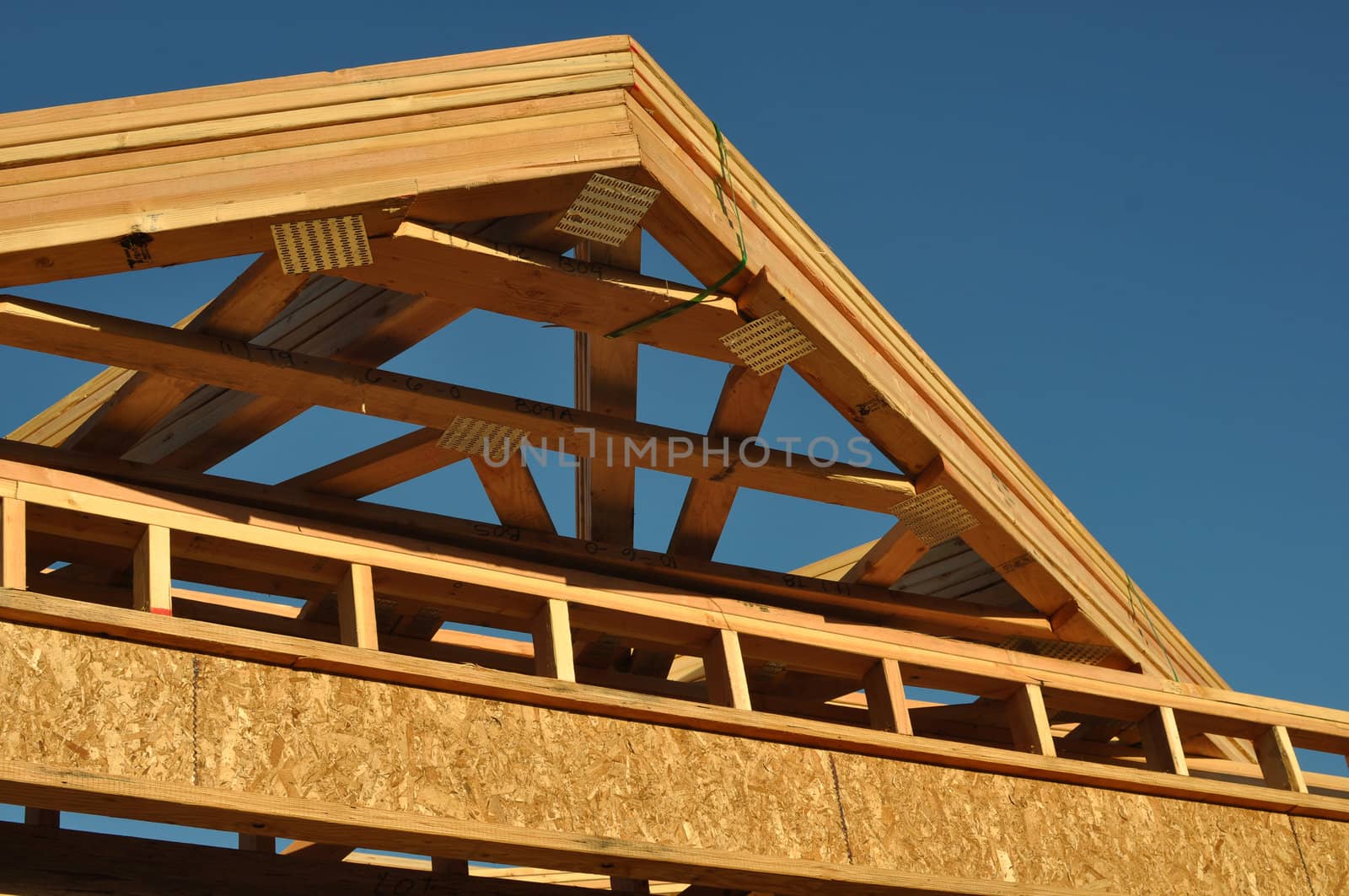 Construction of New Roof on Home with Blue Sky