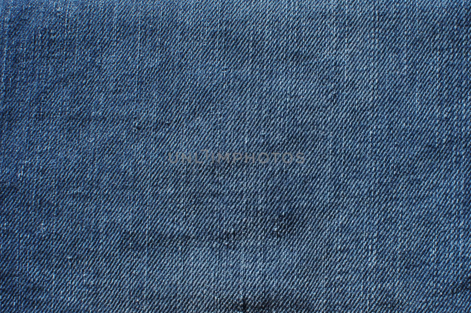 Worn blue jeans made of denim fabric